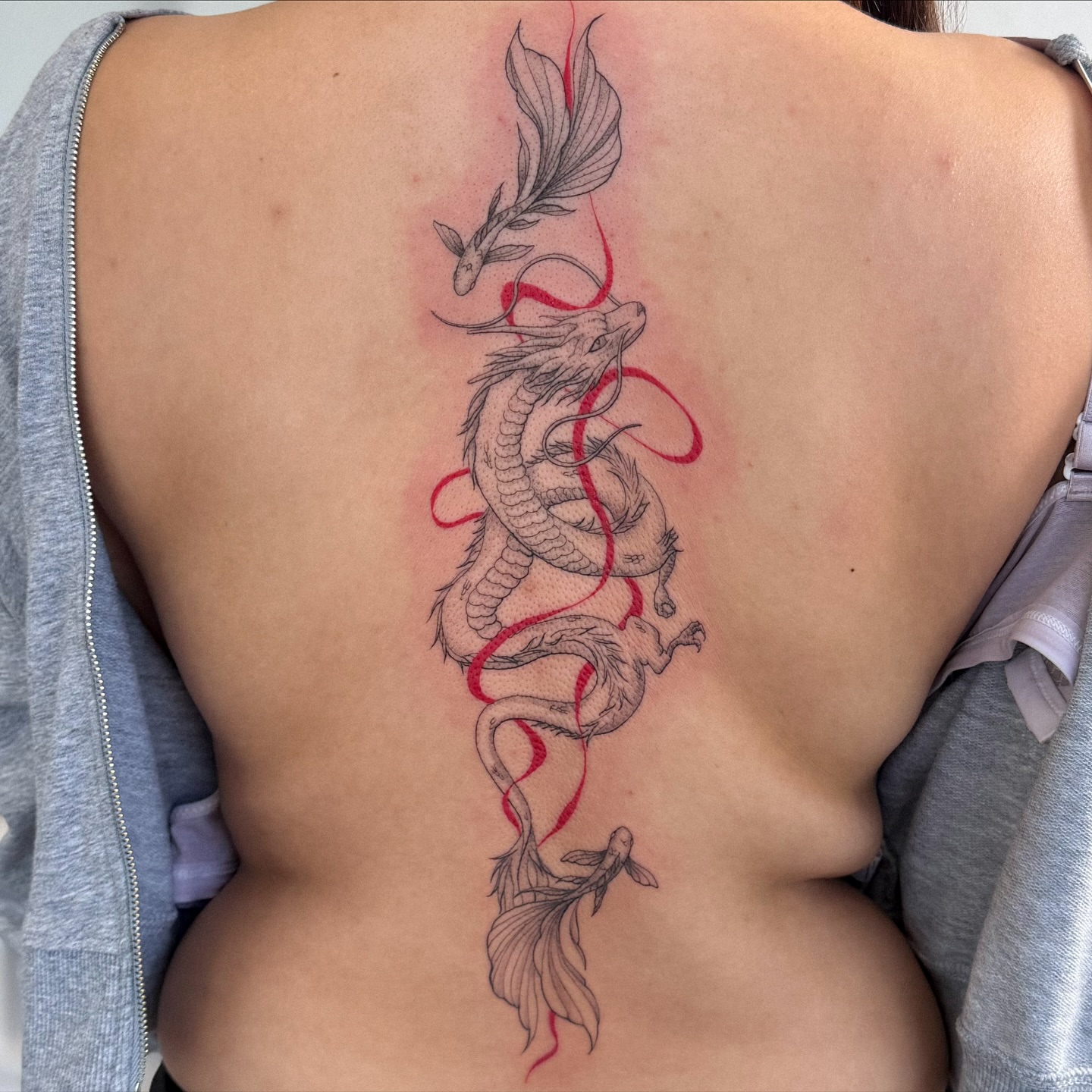 Dragon and fish black and grey tattoo on the back by Daniel Montoya, Charlotte, North Carolina