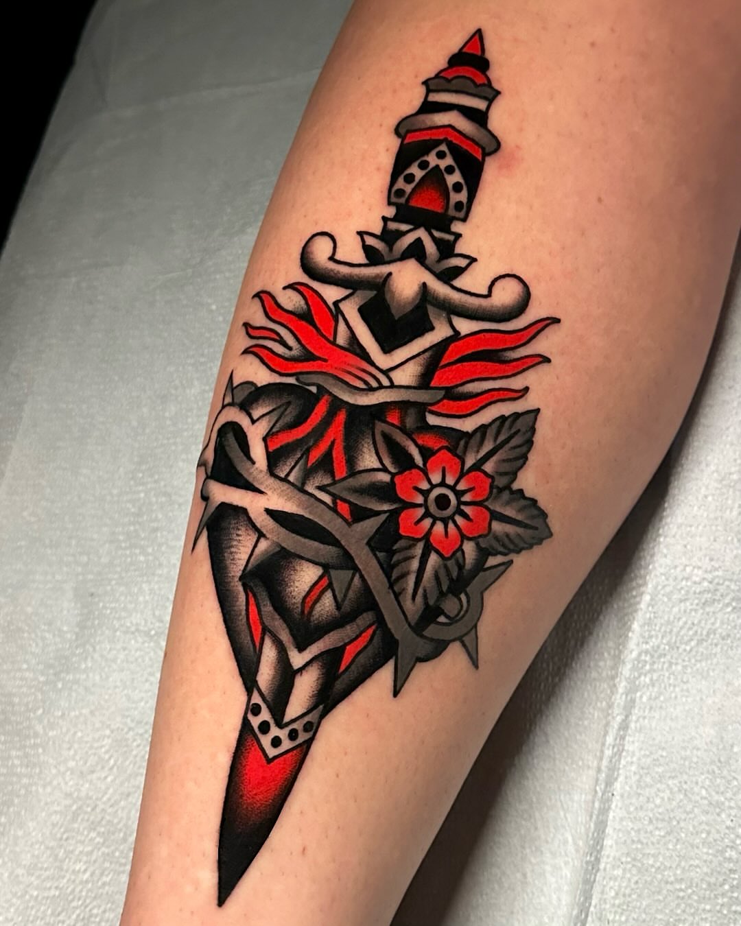 Sword and flower American traditional tattoo on the forearm by Tony Perez- Austin Texas Tattooer