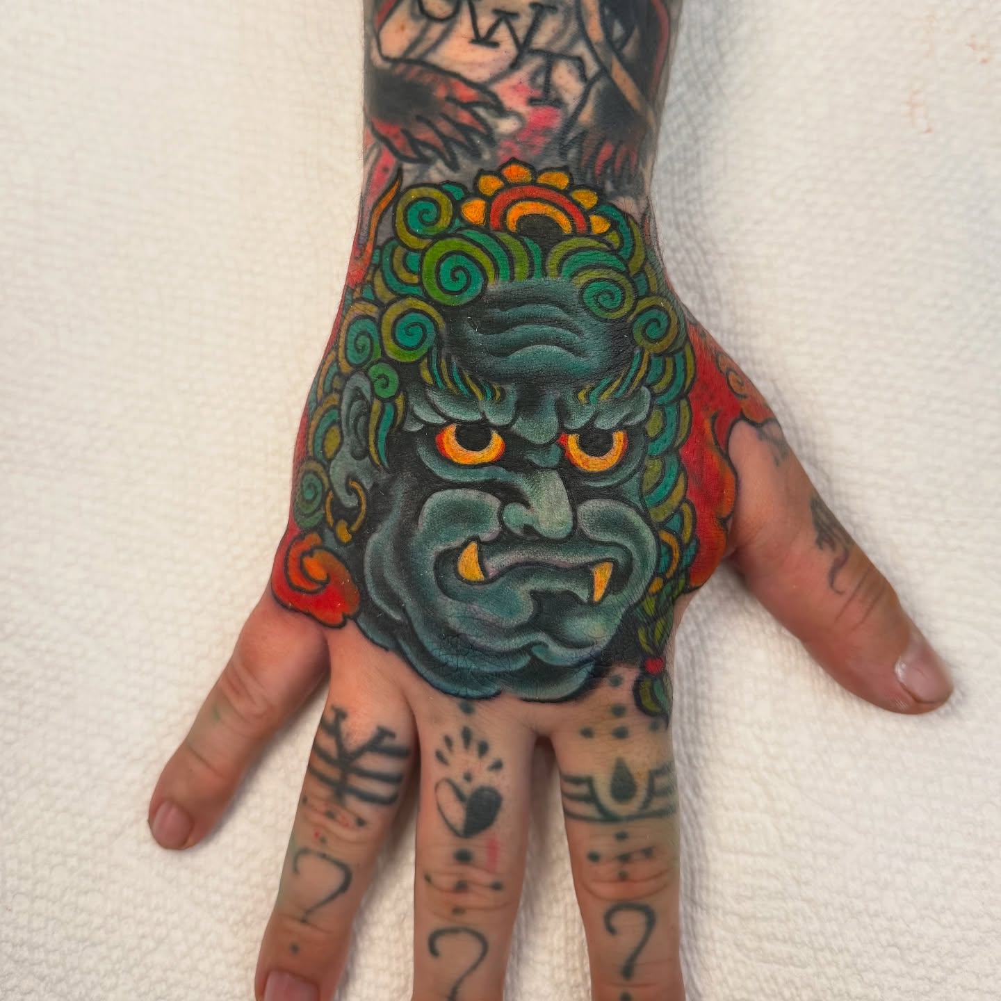 Monster face American traditional tattoo on the hand by Leif Hansen