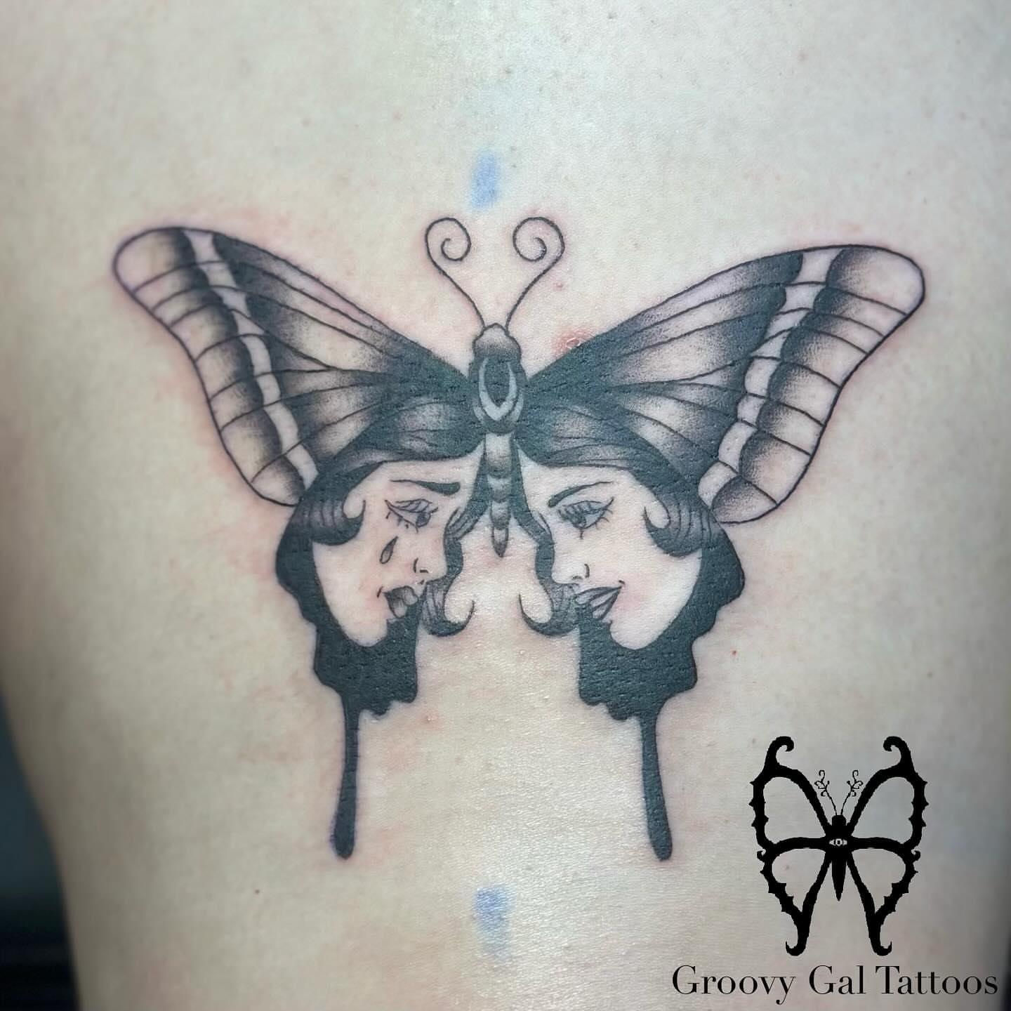 Butterfly with faces realism tattoo on the thigh by Groovy P