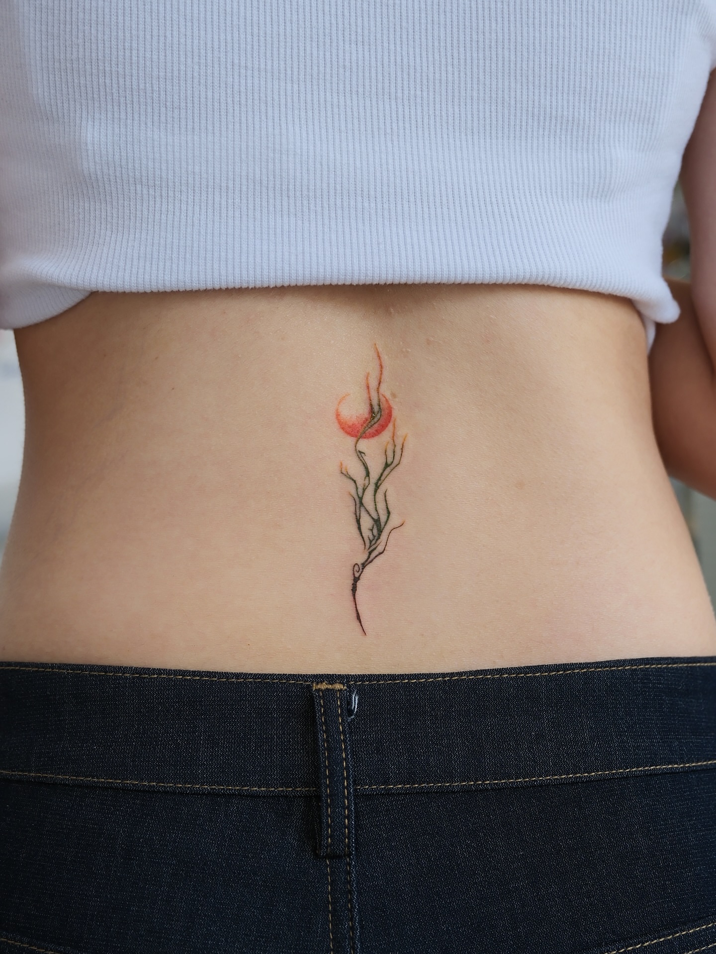 Floral watercolor tattoo on the torso by Max