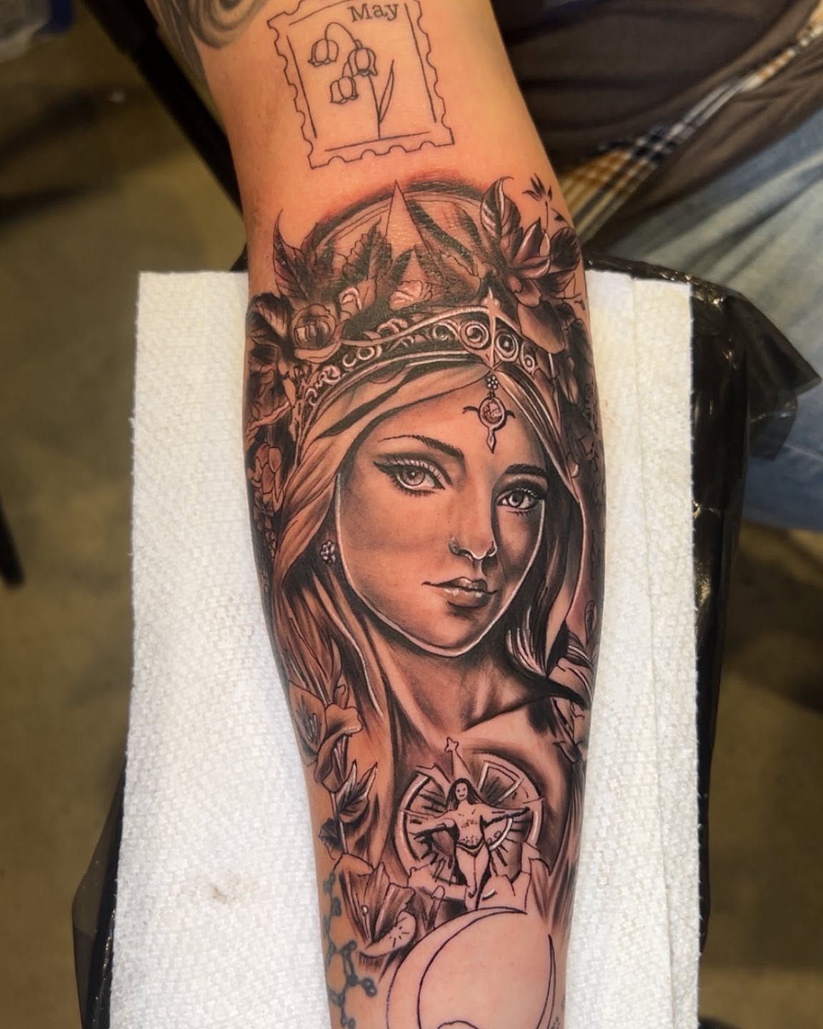 Woman with crown realism tattoo on the forearm by Bryant Ramirez