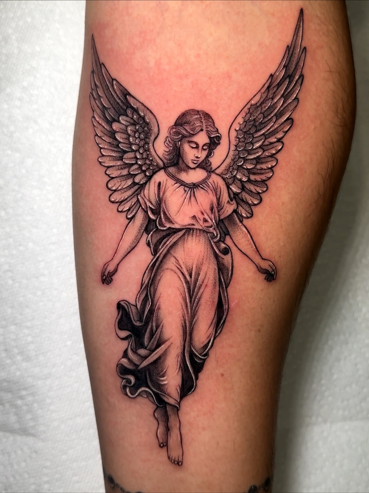 Angel black and grey tattoo on the thigh by Eyekonic Ink