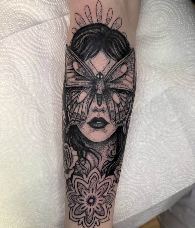 Woman with butterfly dotwork tattoo on the forearm by amanda malia wega