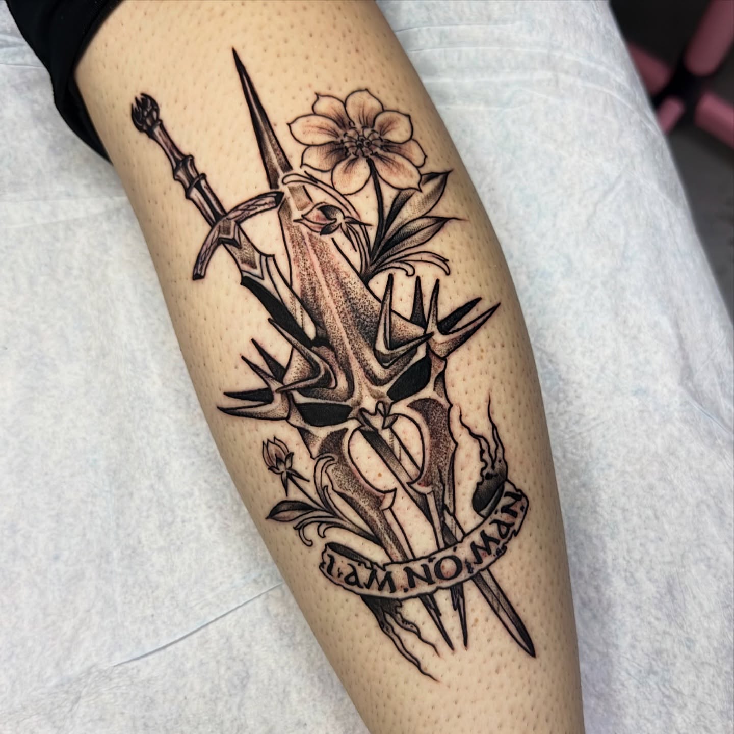 Skull with flowers and dagger realism tattoo on the forearm by Ash Nicola, Asheville, North Carolina