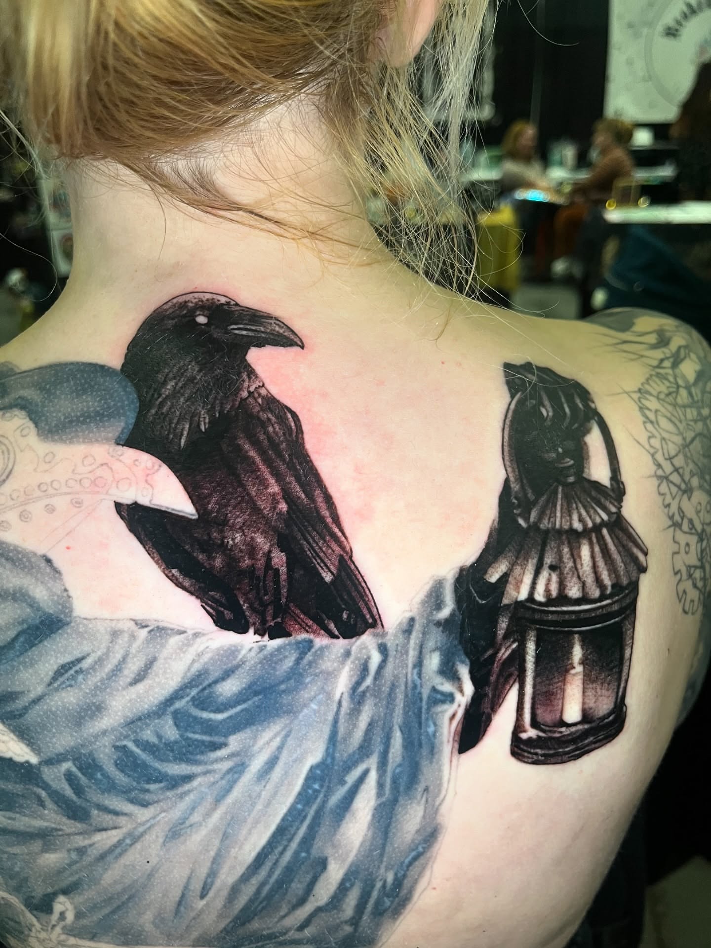 Crow and lantern realism tattoo on the back by Brennan Freemantle