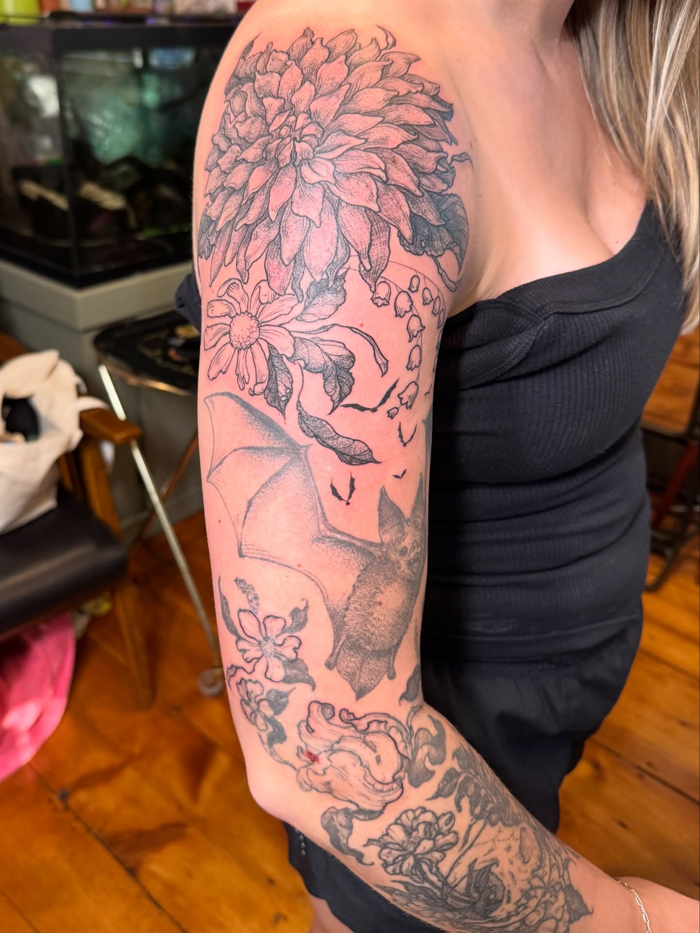 Flower and bat black and grey tattoo on the forearm by Rebeka Chase [Sobodacha]