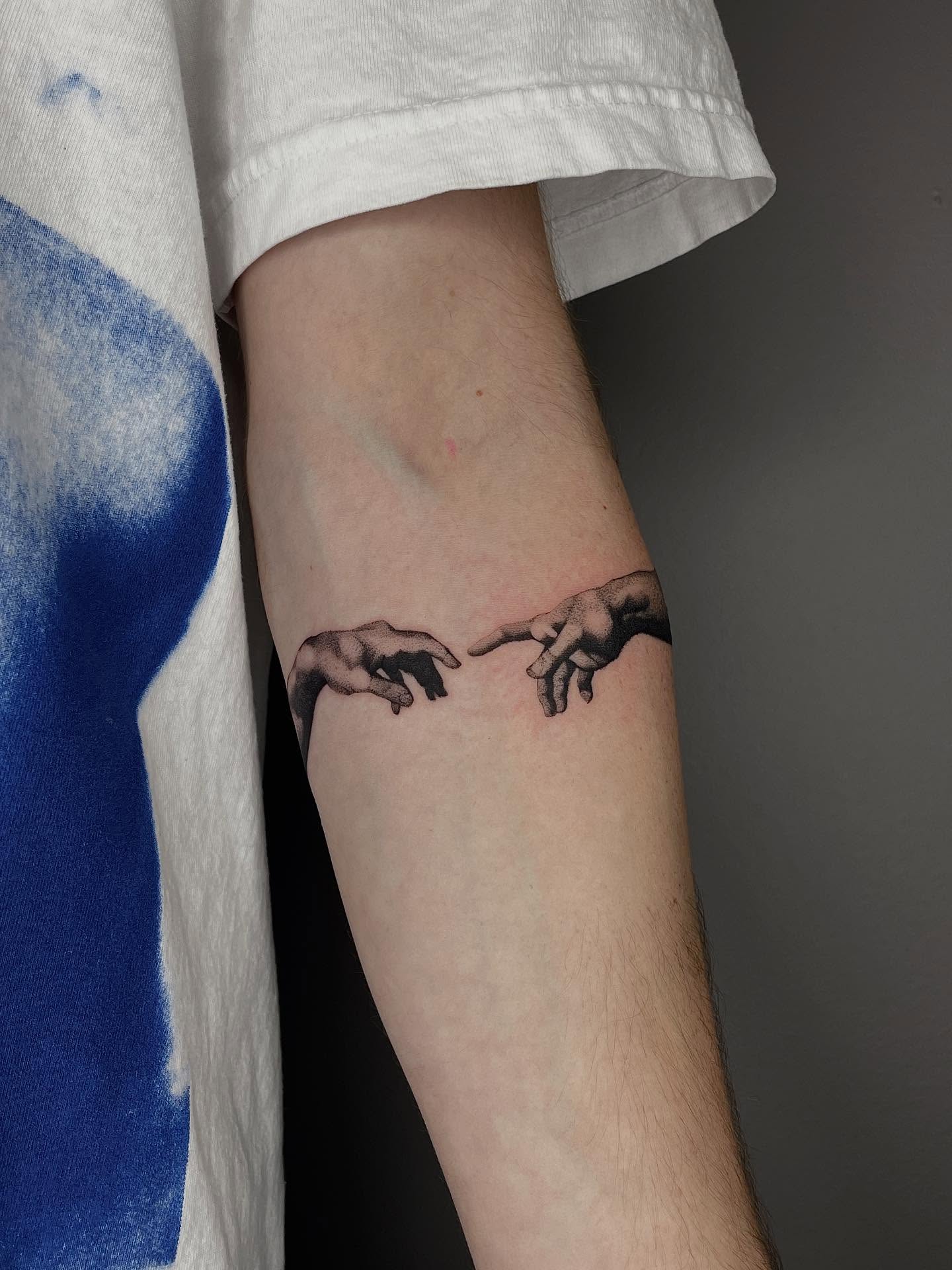 Creation moment black and grey tattoo on the forearm by Thiên Hồ