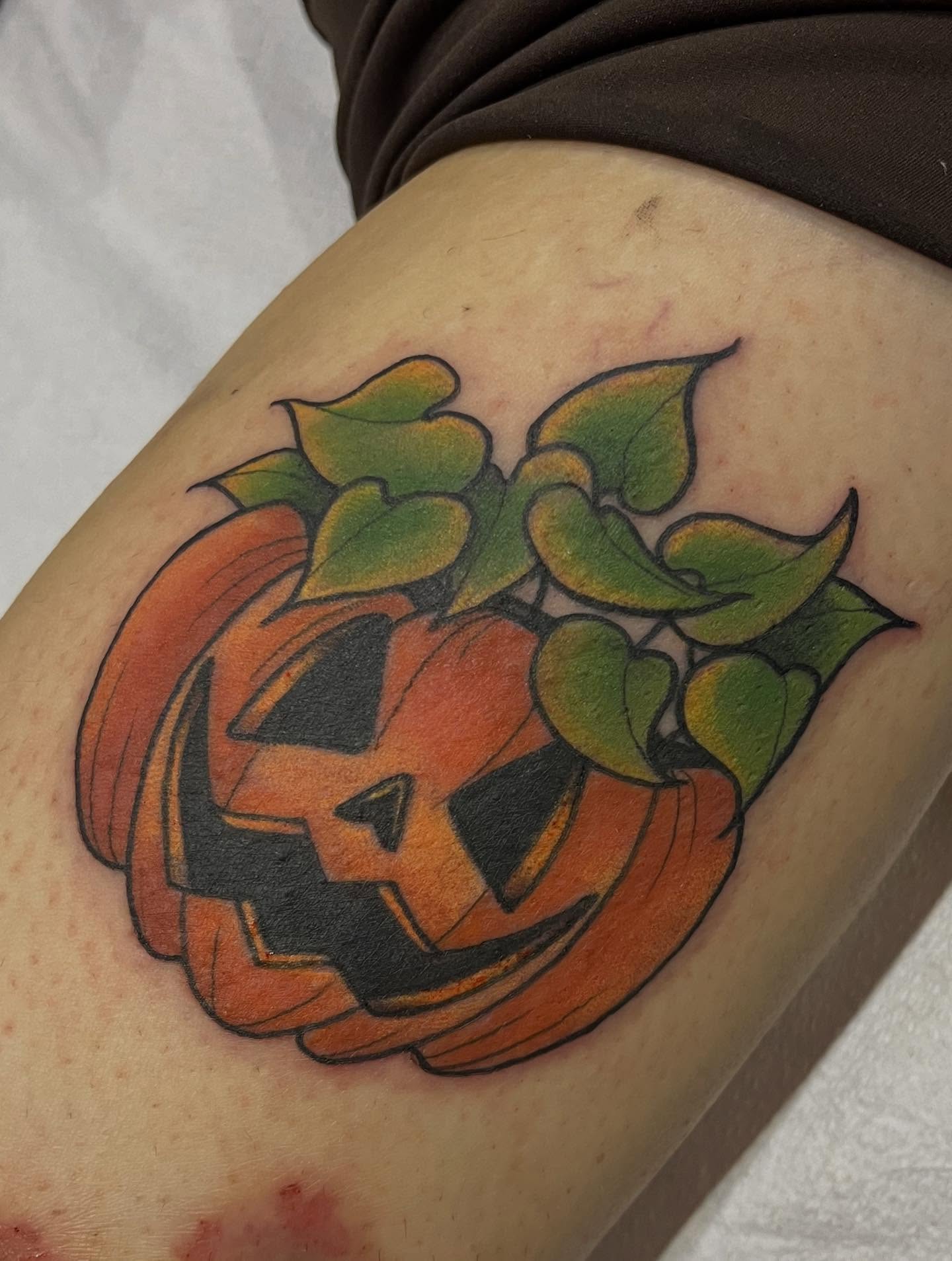 Pumpkin American traditional tattoo on the thigh by Lauren Bumgardner