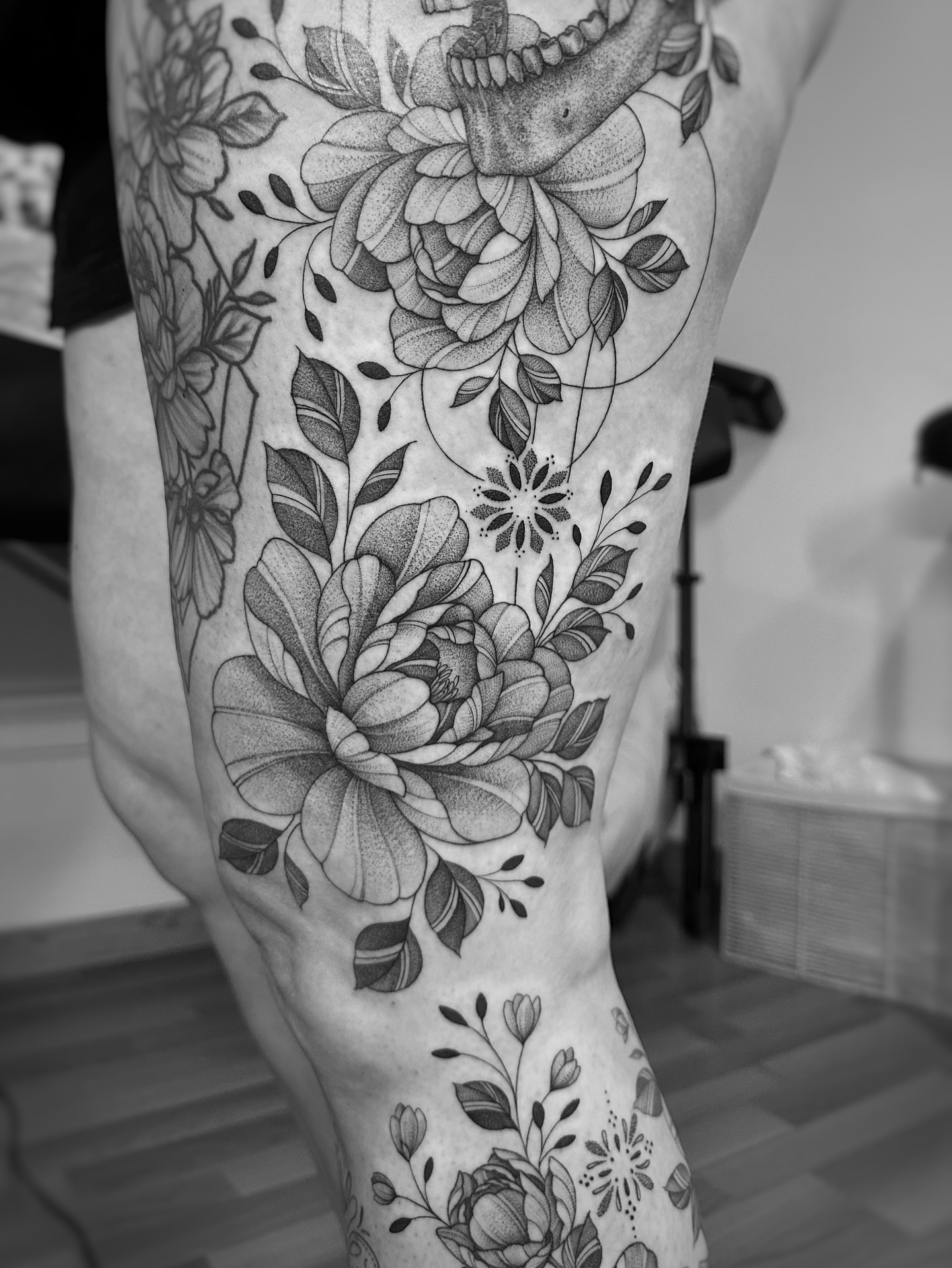 Floral arrangement dotwork tattoo on the thigh by jaclyn park