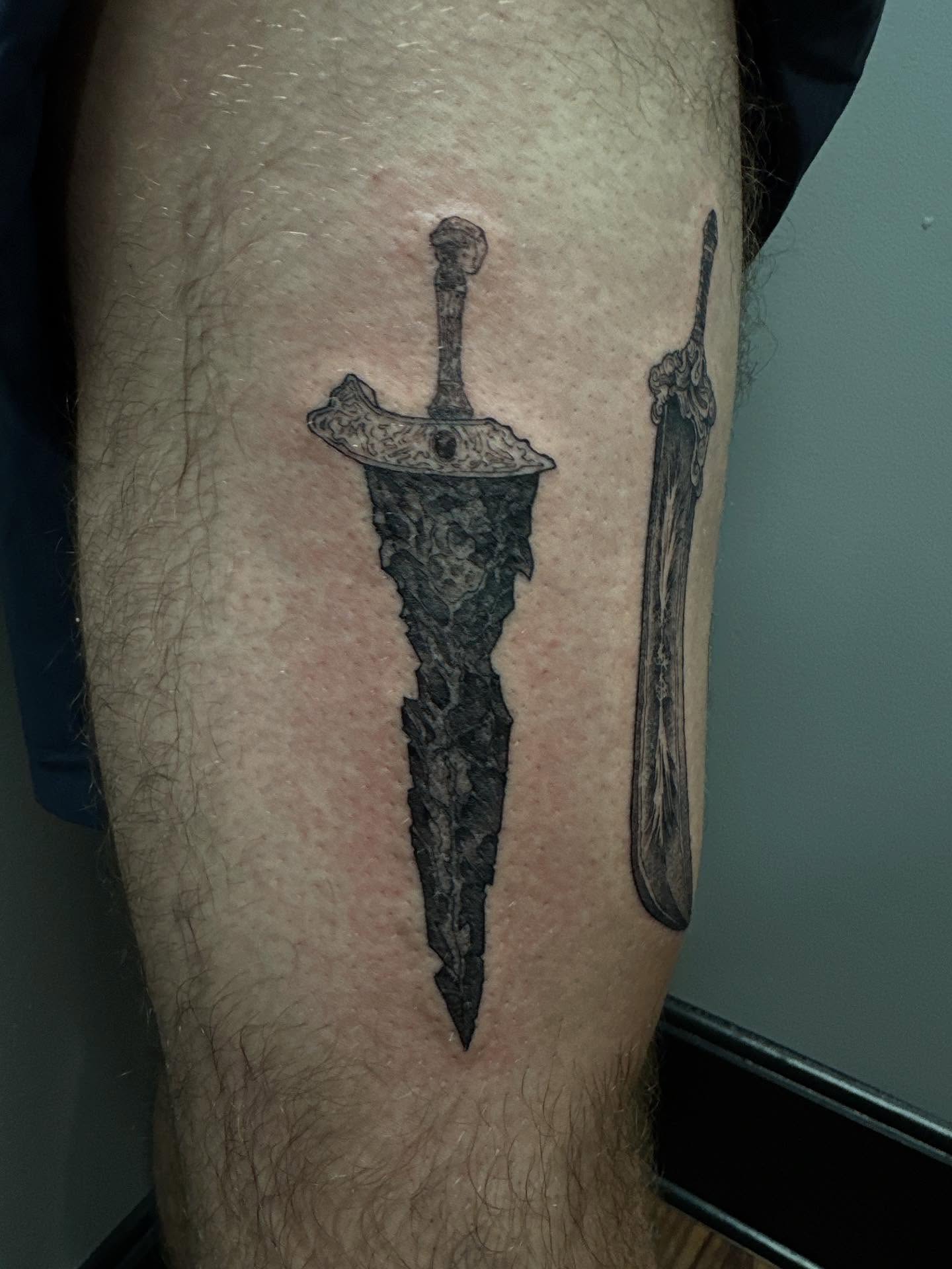 Sword black and grey tattoo on the leg by Jan Xander