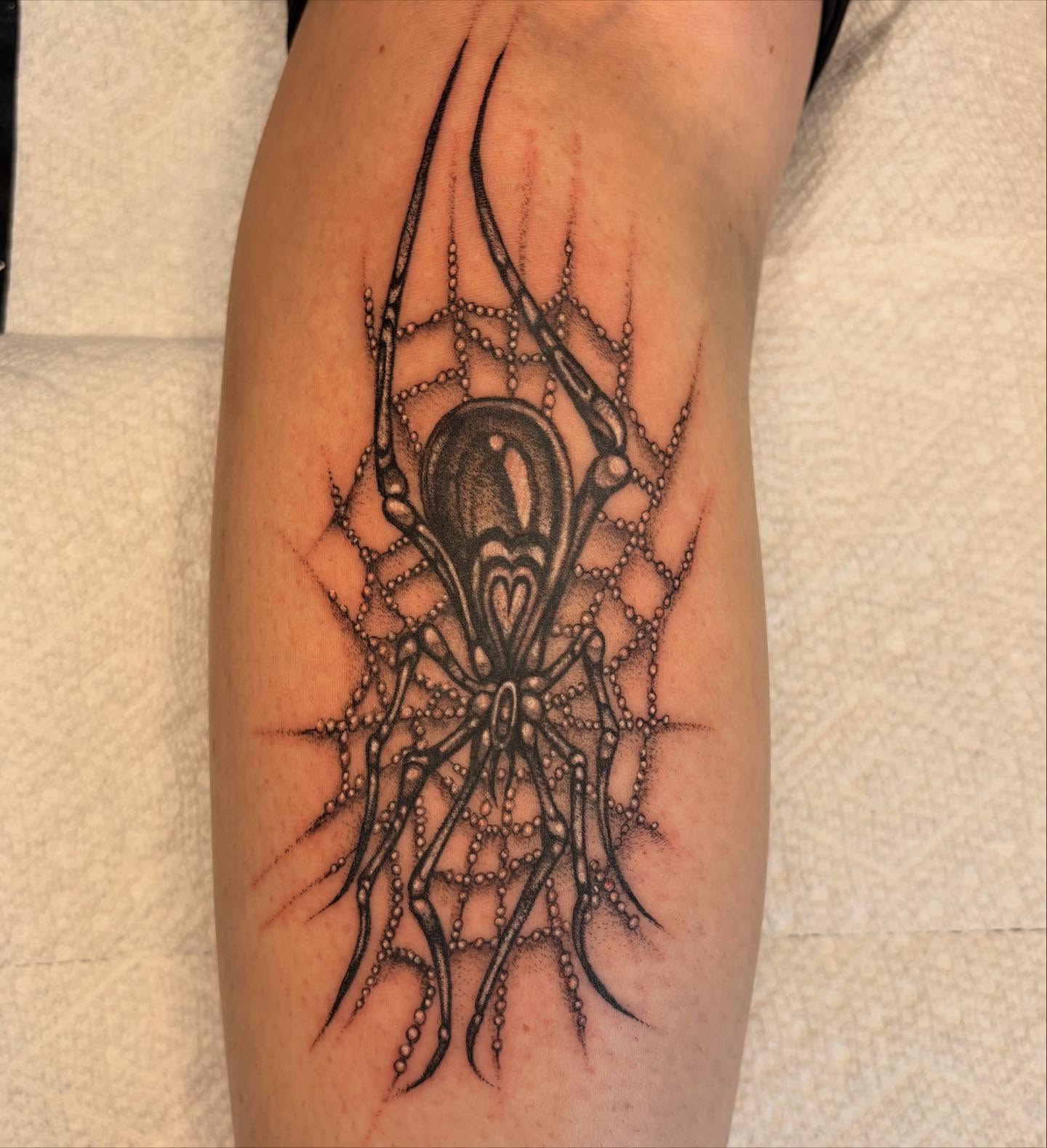 Spider web dotwork tattoo on the forearm by Brendan Smith
