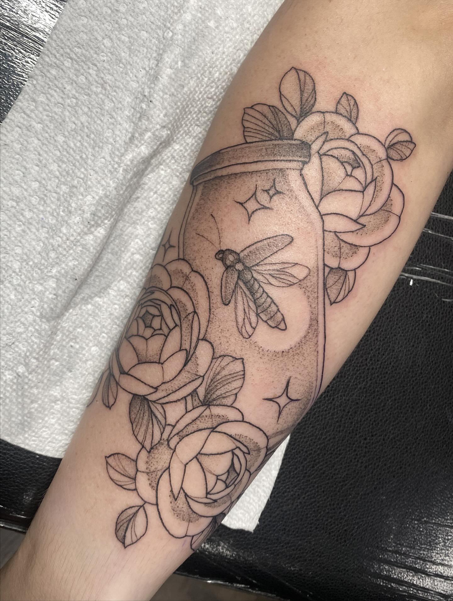Jar with dragonfly and roses black and grey tattoo on the forearm by K A R L y K I T S O N