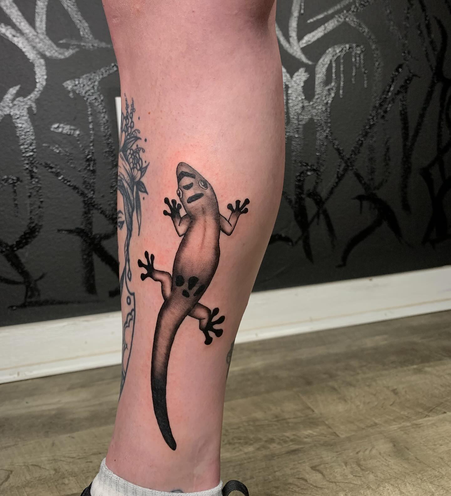 Gecko black and grey tattoo on the calf by Devon