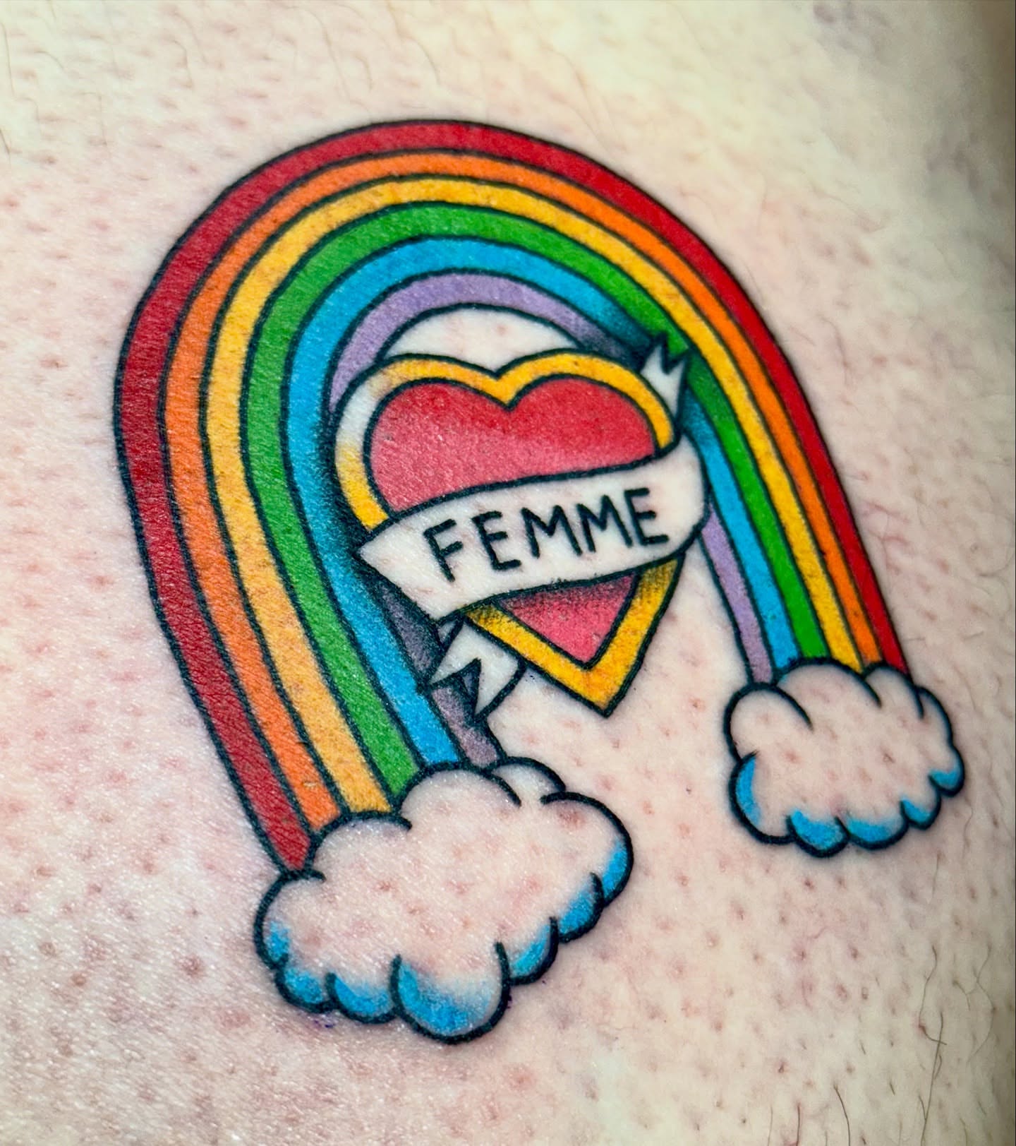 Rainbow heart American traditional tattoo on the thigh by Sophie McTear