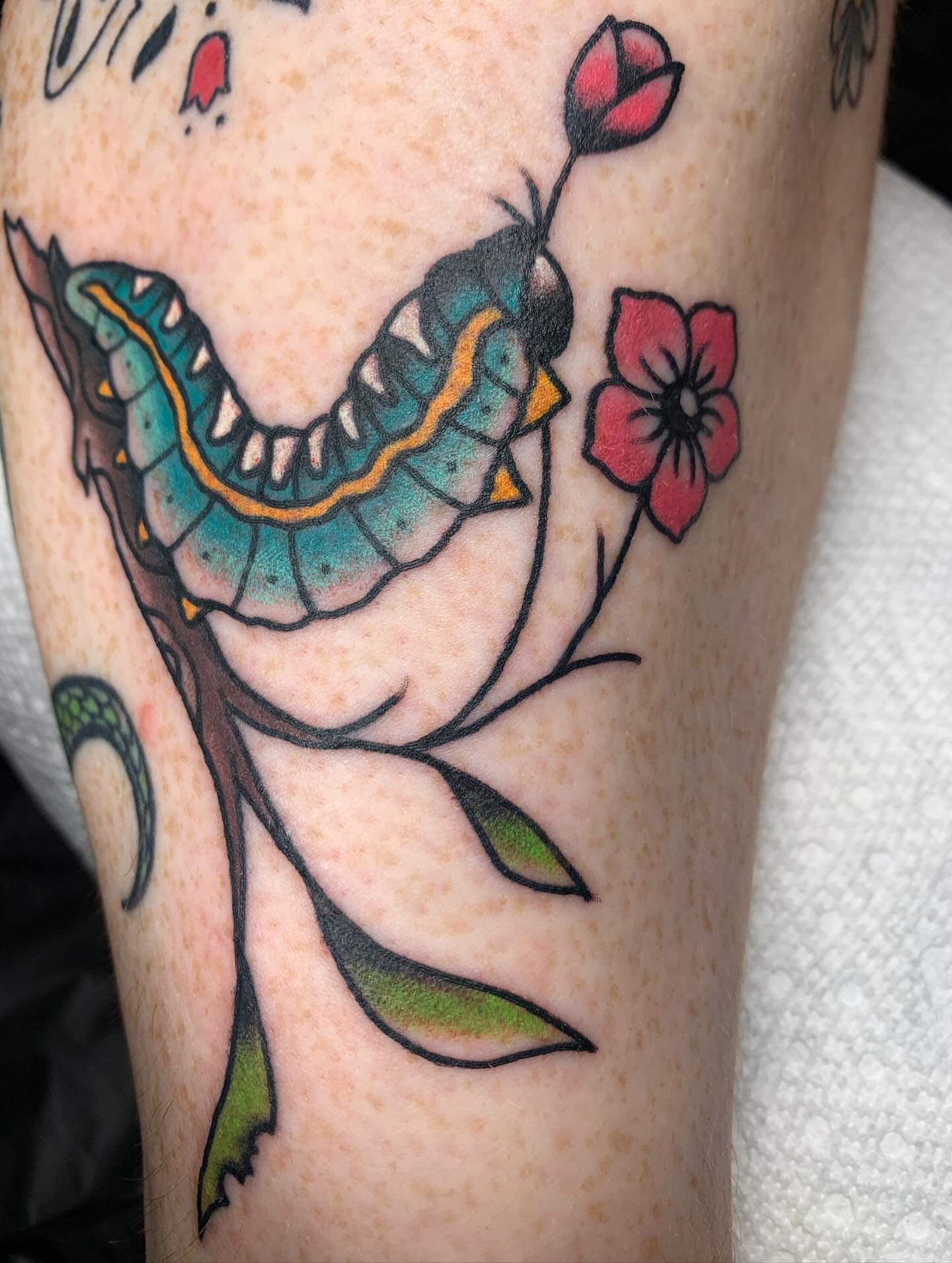 Worm and flowers American traditional tattoo on the forearm by April Morris ⚔️ Tattoo Goblin
