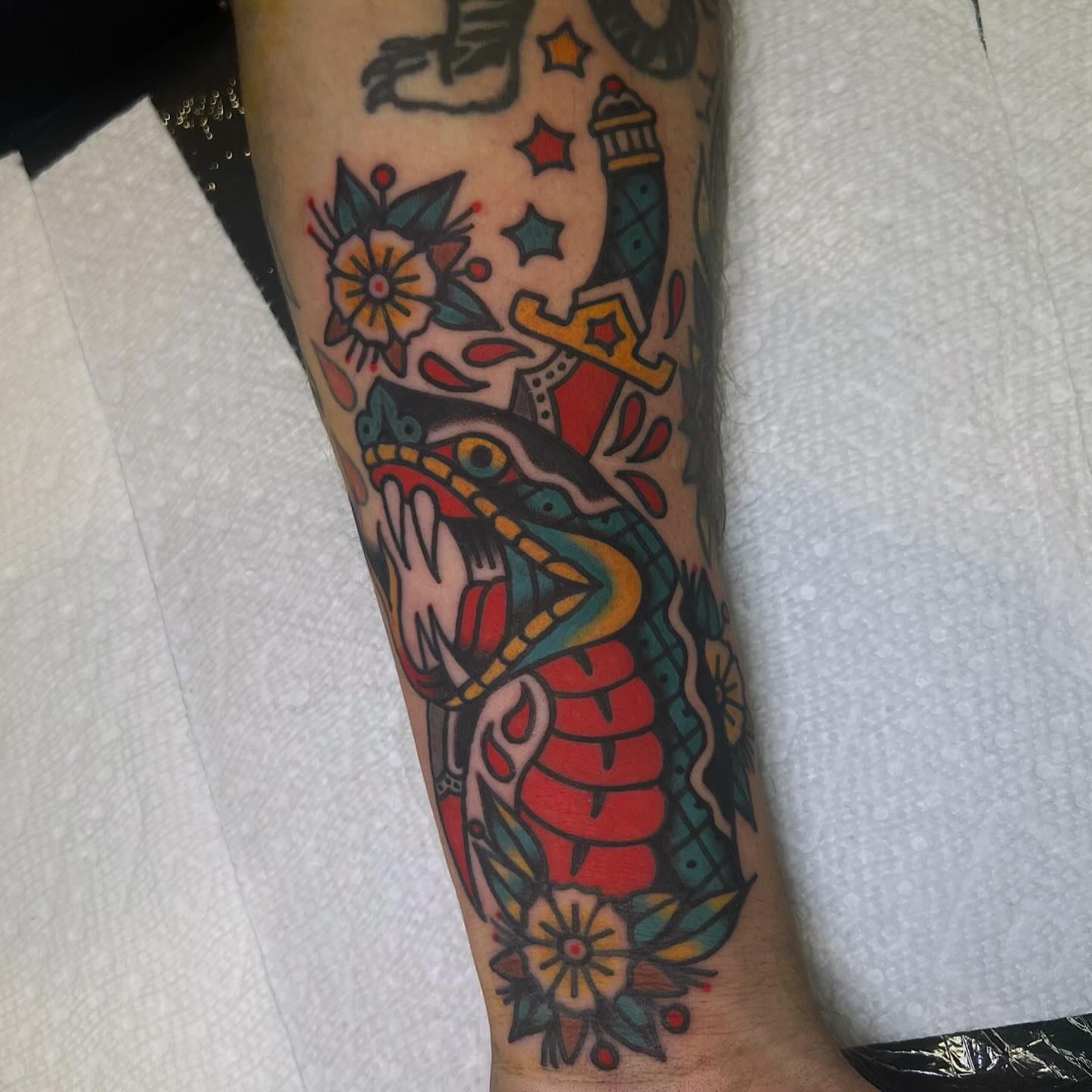 Snake and crown American traditional tattoo on the forearm by Benjamin Ward