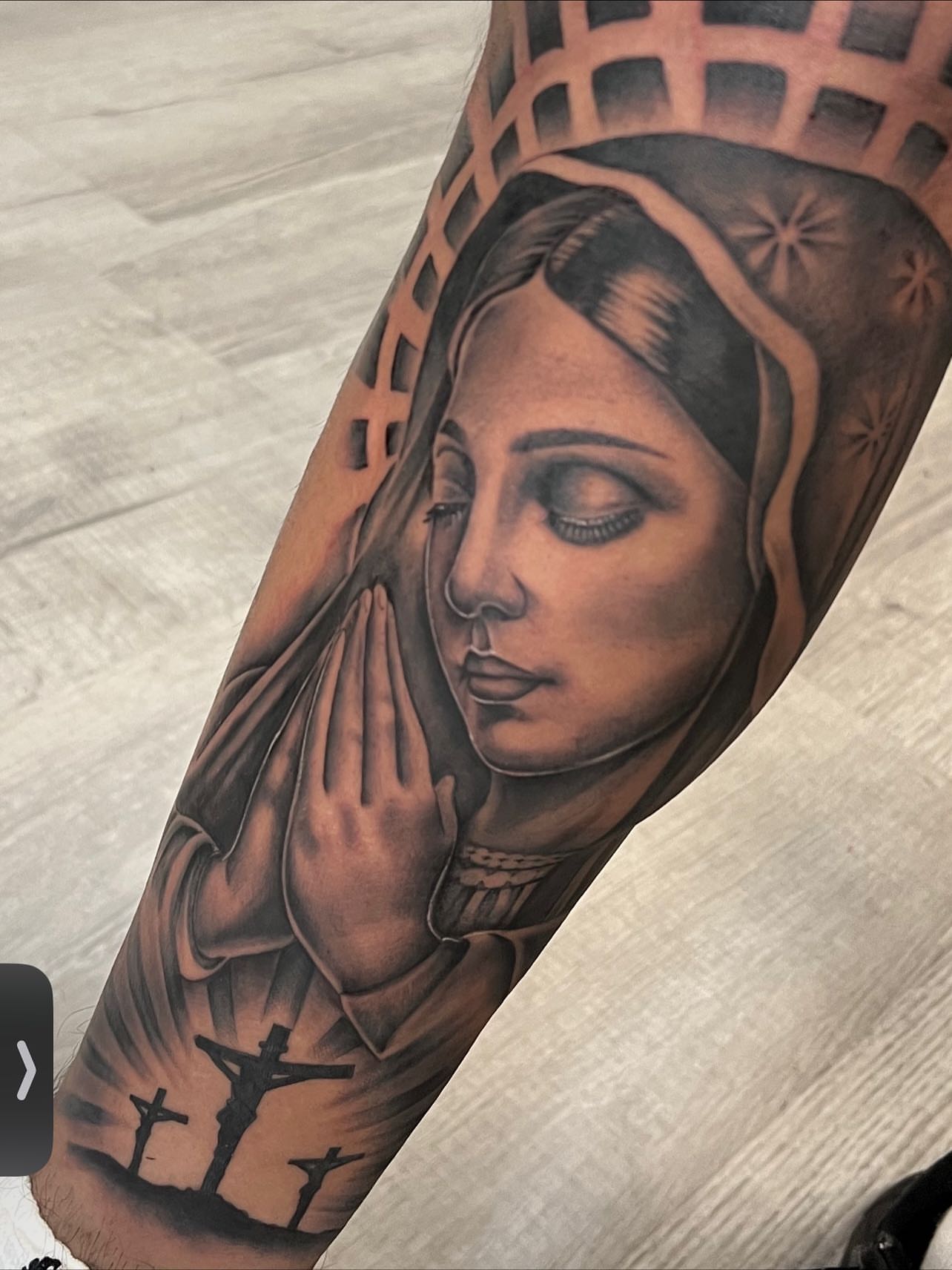 Religious figure realism tattoo on the forearm by Hugo Ruiz-Esparza