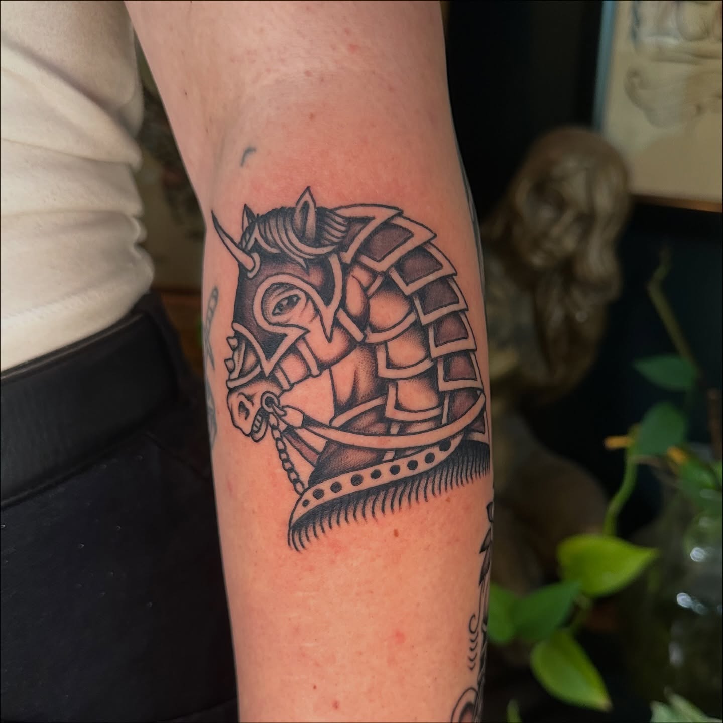 Bull in armor black and grey tattoo on the forearm by Max Peterson