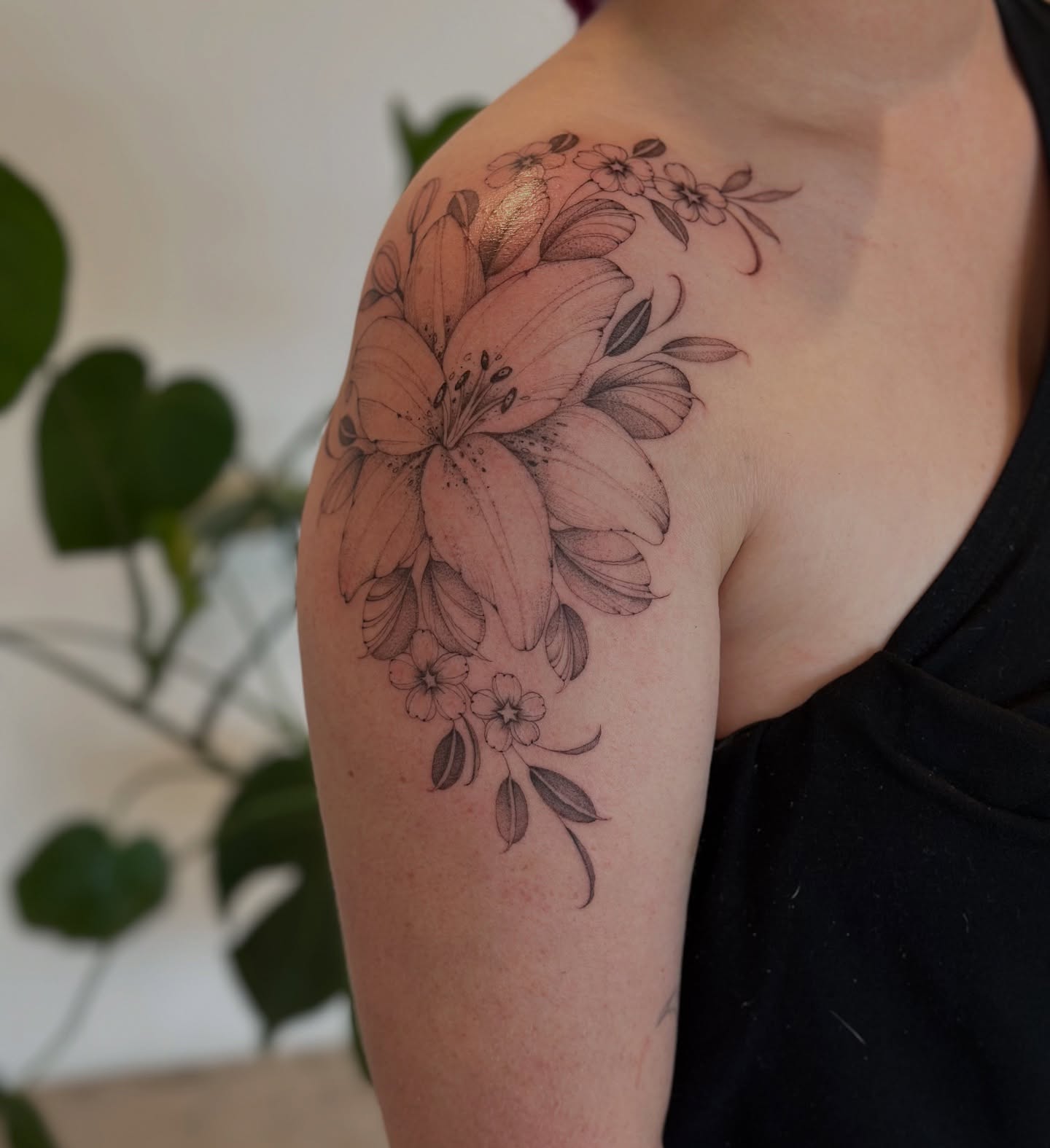 Lilies and flowers black and grey tattoo on the shoulder by ᴍɪᴄʜᴇʟʟᴇ, New York, New York