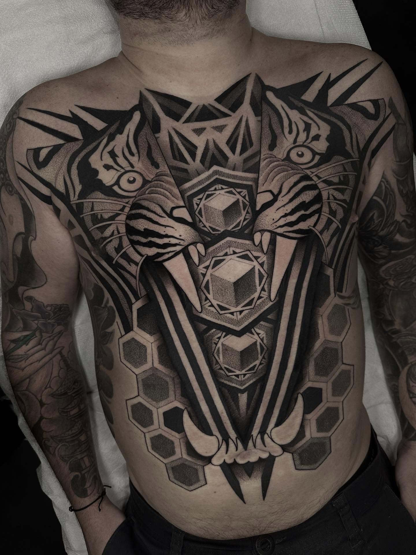 Geometric tiger geometric tattoo on the chest by Kevin Johnson