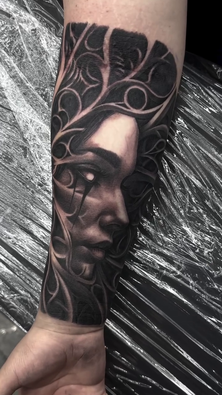 Woman's face with abstract elements dark realism tattoo by Michael Sosa