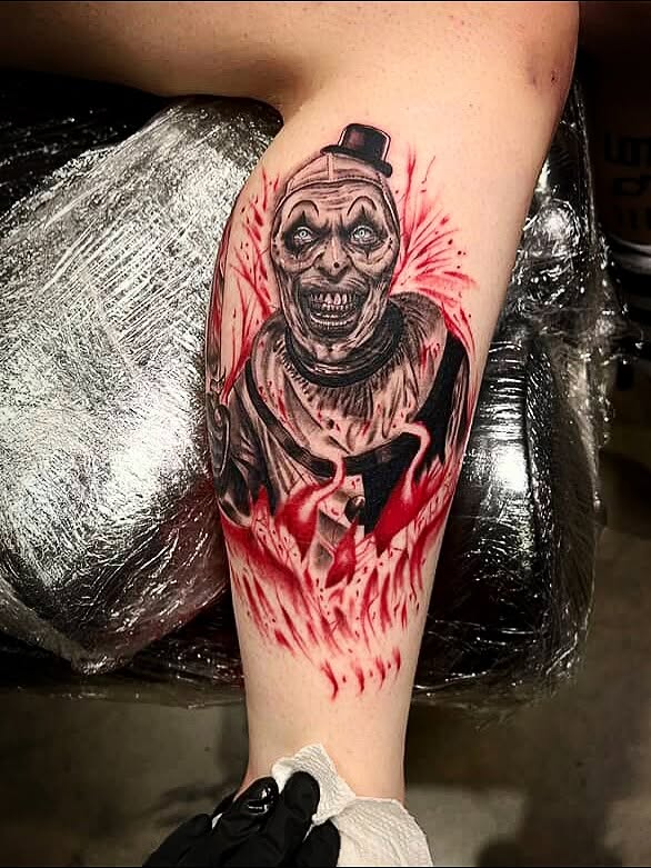 Clown dark realism tattoo on the forearm by Denis Seregin