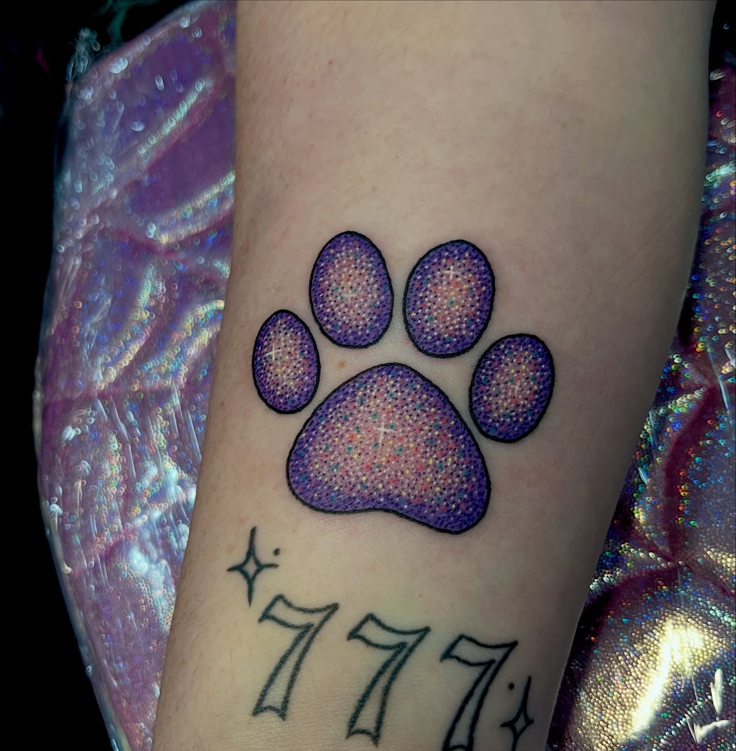 Paw print dotwork tattoo on the forearm by Cheyanne Peck