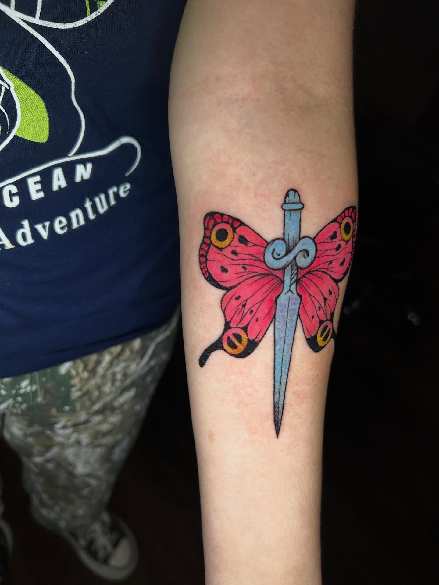 Butterfly and dagger new school tattoo on the forearm by Abby Camacho - Tattoo Artist and Piercer โจ๐