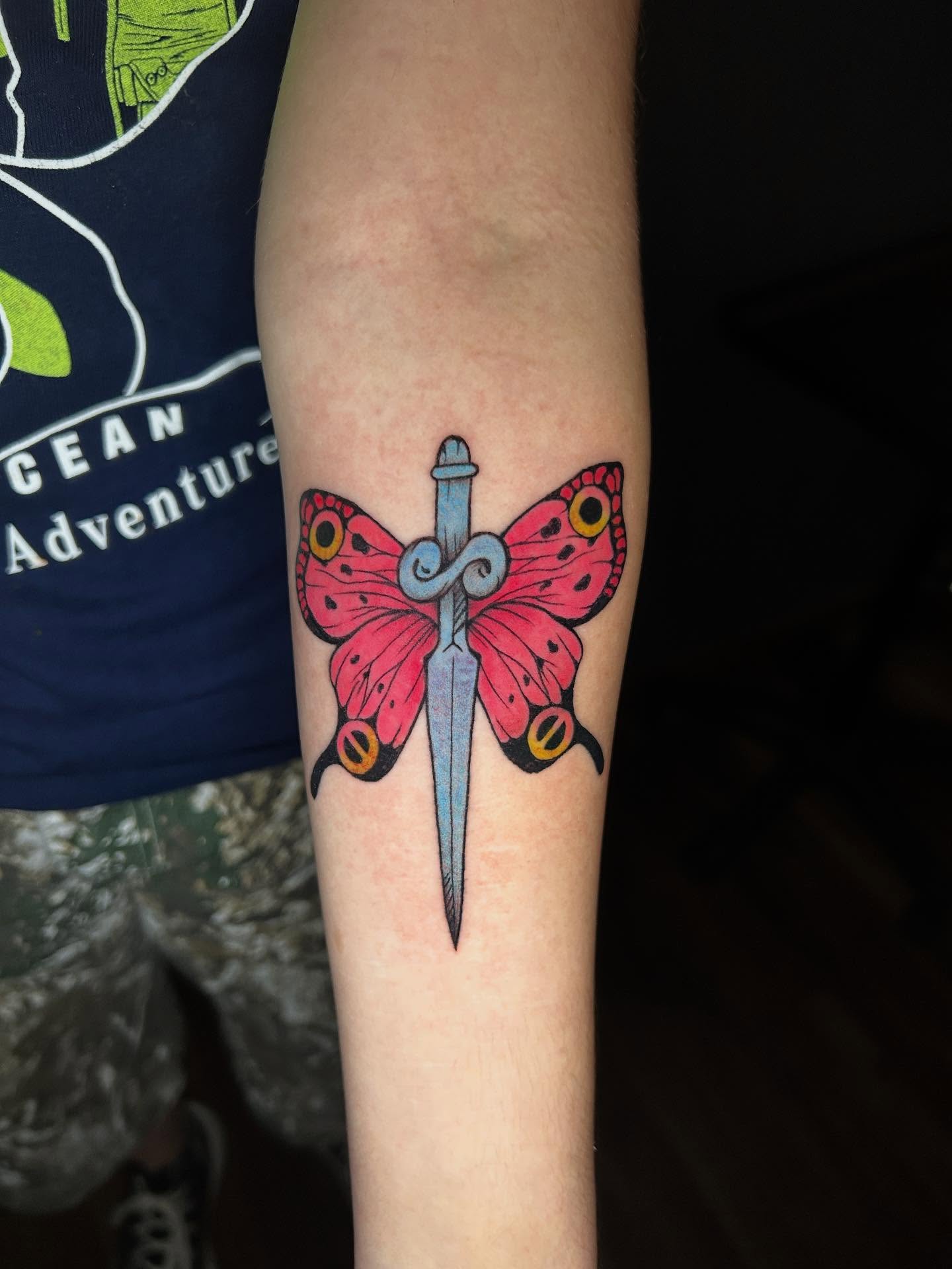 Butterfly and dagger American traditional tattoo on the forearm by Abby Camacho - Tattoo Artist and Piercer โจ๐