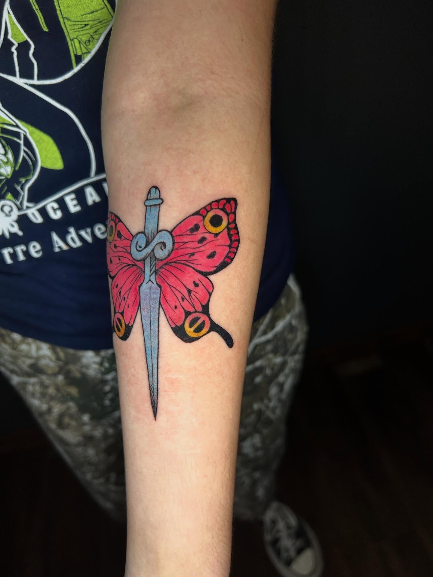 Butterfly and sword American traditional tattoo on the forearm by Abby Camacho - Tattoo Artist and Piercer โจ๐