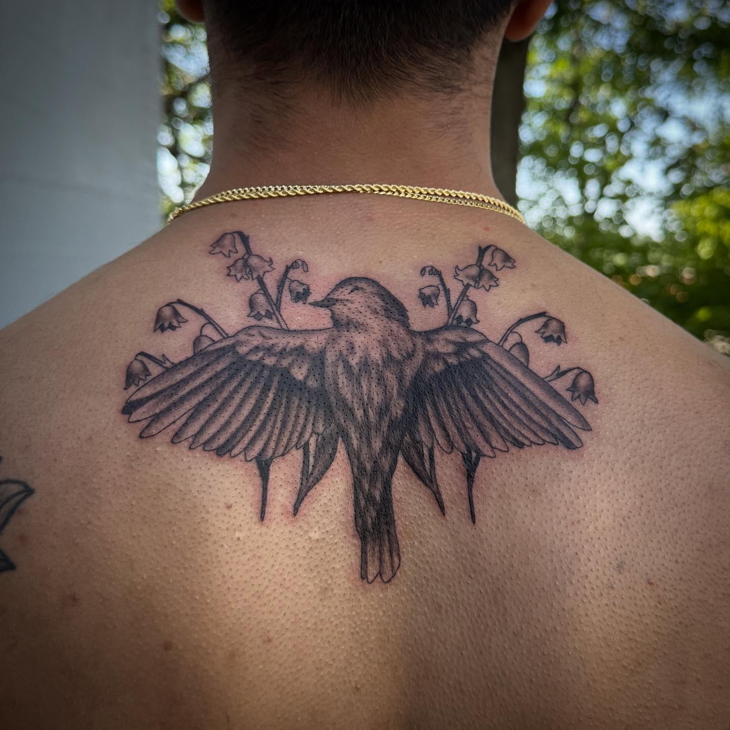 Bird and flowers dotwork tattoo on the back by Alexis Monkiewicz