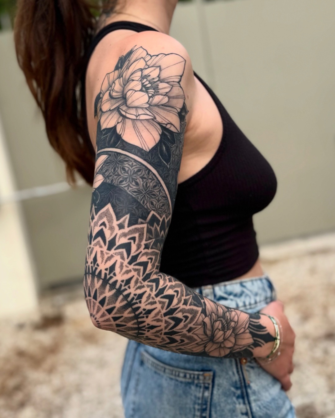 Floral mandala geometric tattoo on the upper arm by Laure Conzales