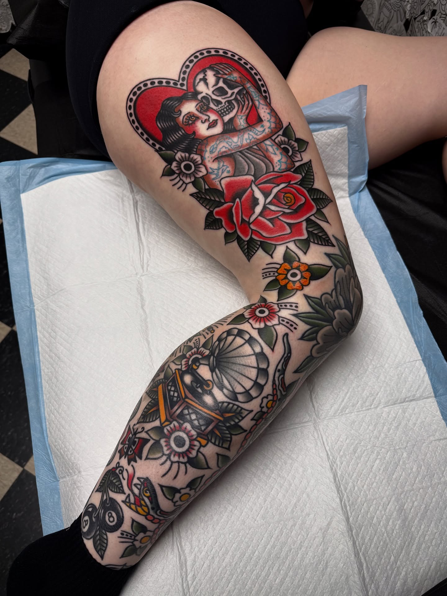 Sugar skull couple American traditional tattoo on the thigh by Jordan Allen