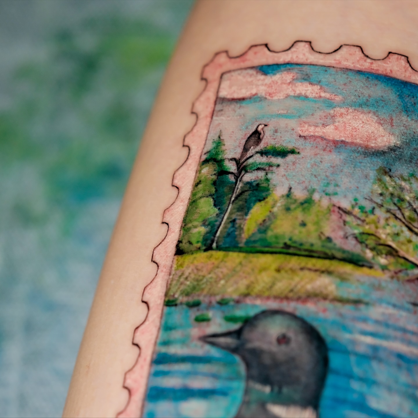 Landscape with bird watercolor tattoo on the forearm by NAS