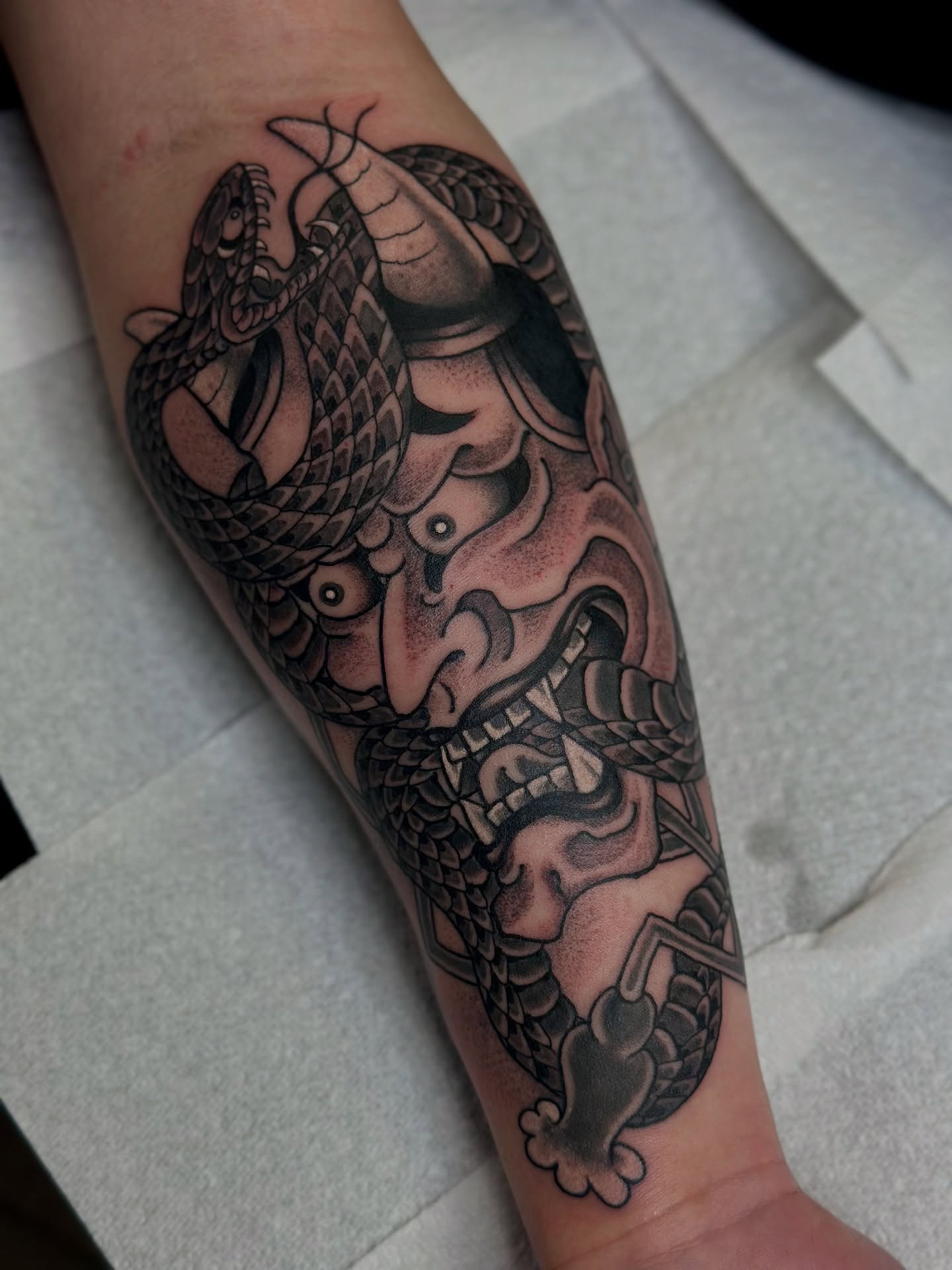 Dragon and armor realism tattoo on the forearm by B e A U B R A D y, Costa Mesa, California