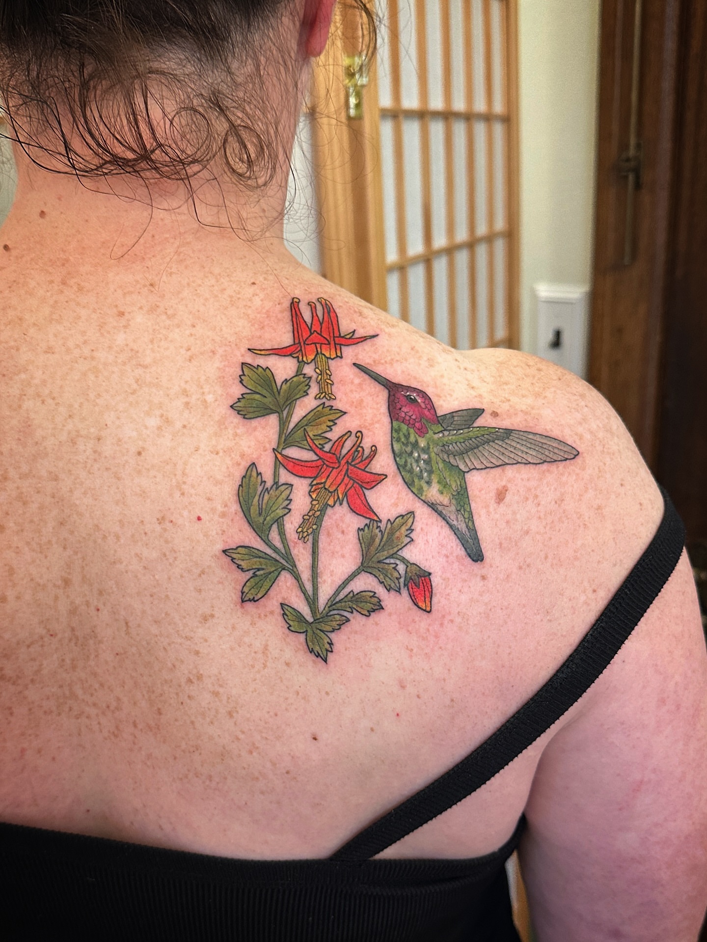 Hummingbird and fuchsia realism tattoo on the shoulder by Tattooing by Patty Valentine