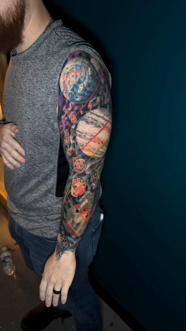 Planets and astronaut realism tattoo by Krys King Tattoos