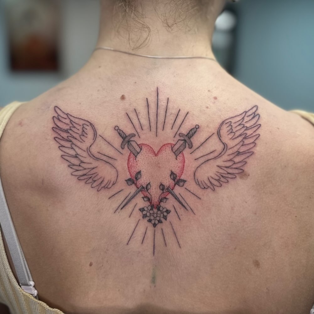 Heart with wings American traditional tattoo on the back by Bell