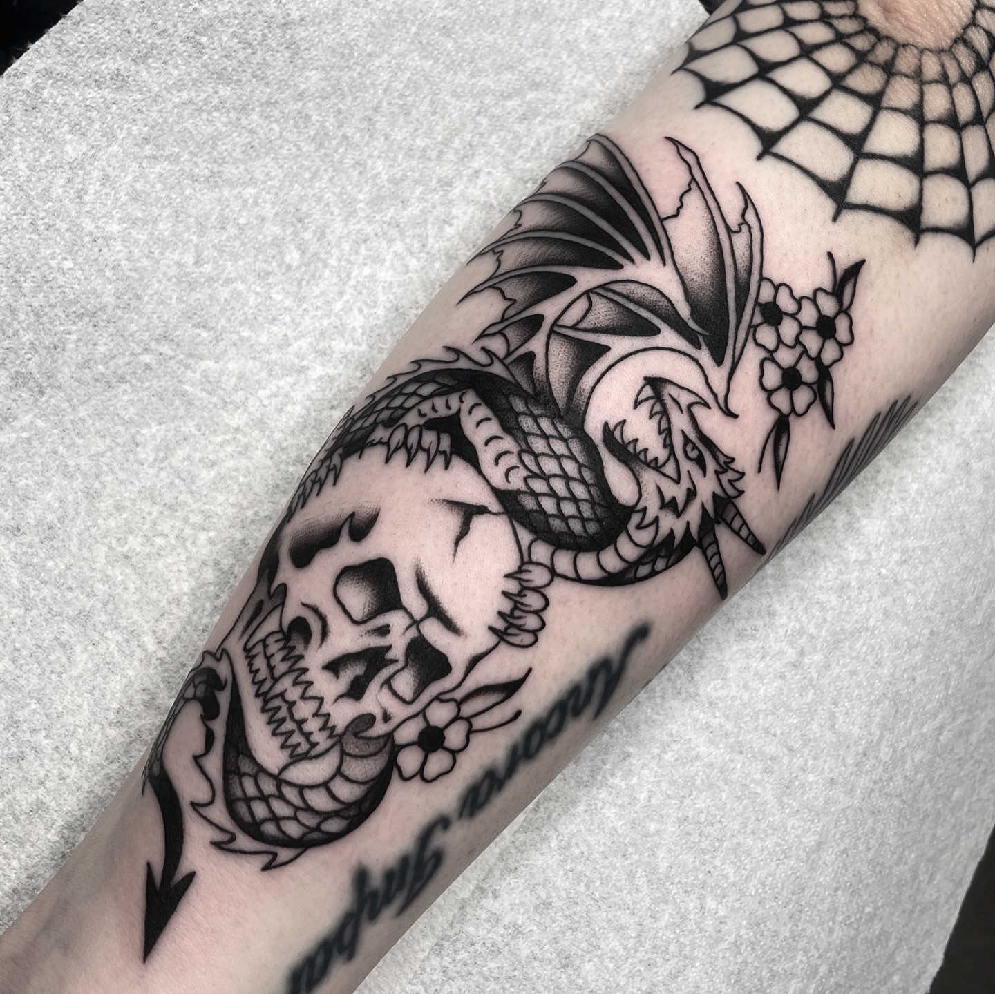 Dragon and skull realism tattoo on the forearm by Dakota Jenner