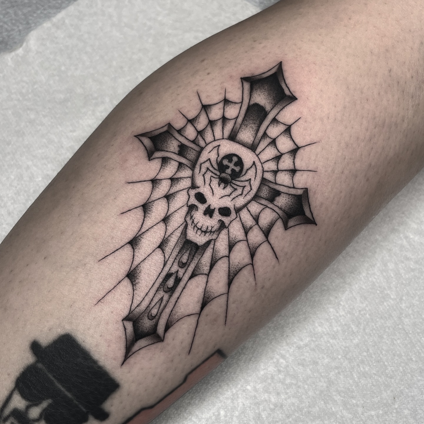 Cross with skull dotwork tattoo on the forearm by Dakota Jenner