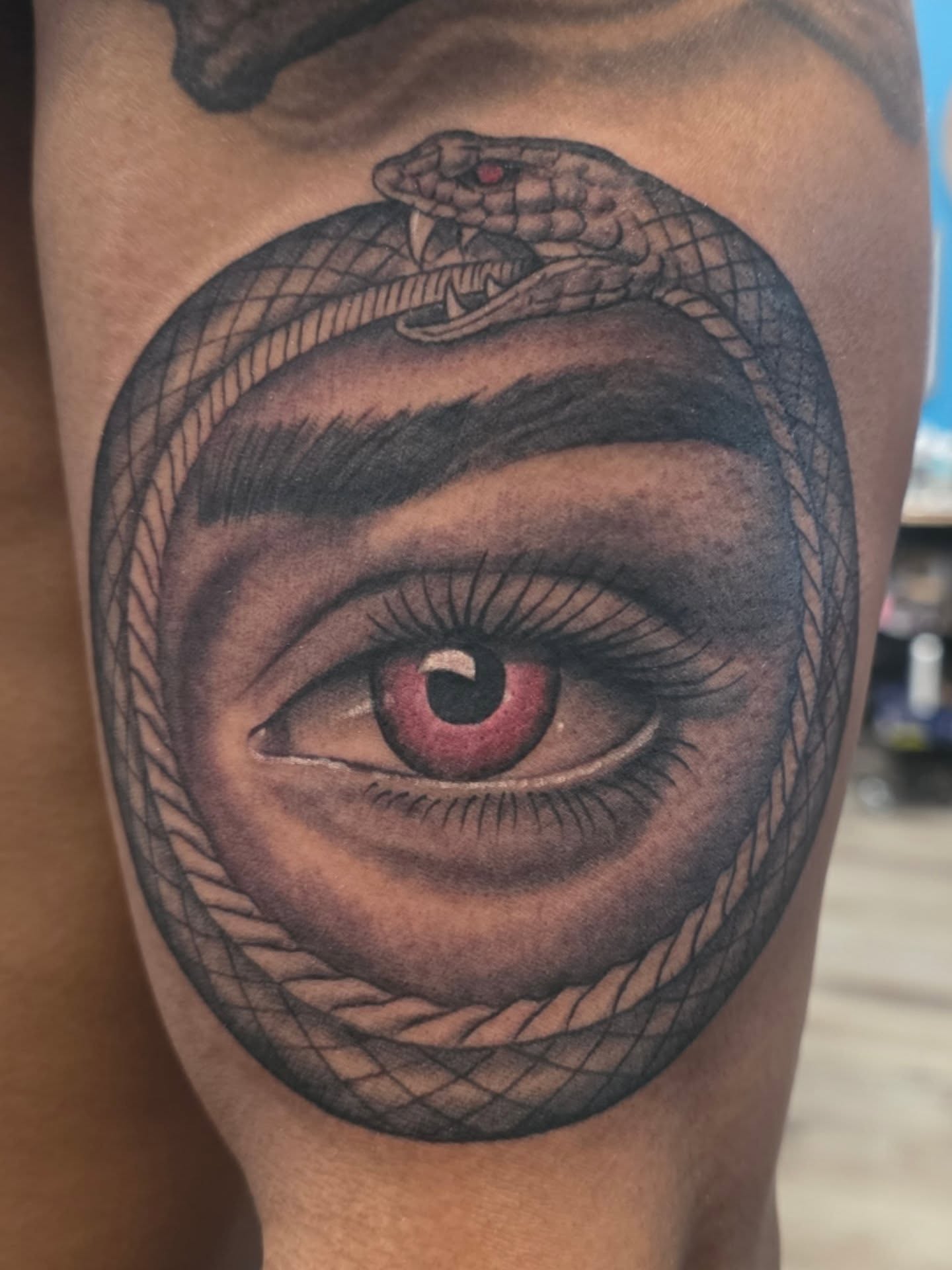 Eye with snake realism tattoo on the forearm by Martin Colonna