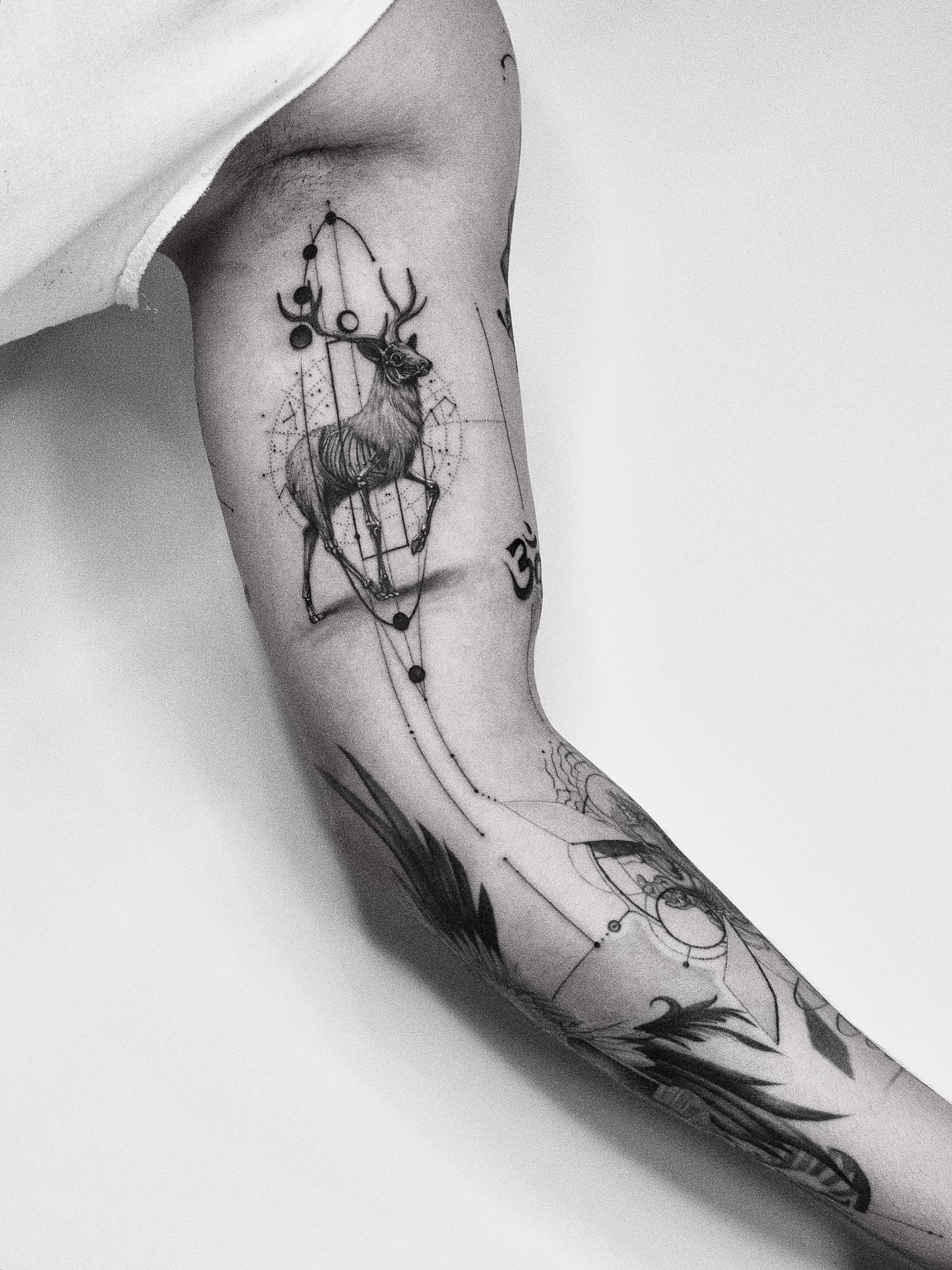 Deer and geometric shapes geometric tattoo on the forearm by János Bozóki, Budapest, Hungary
