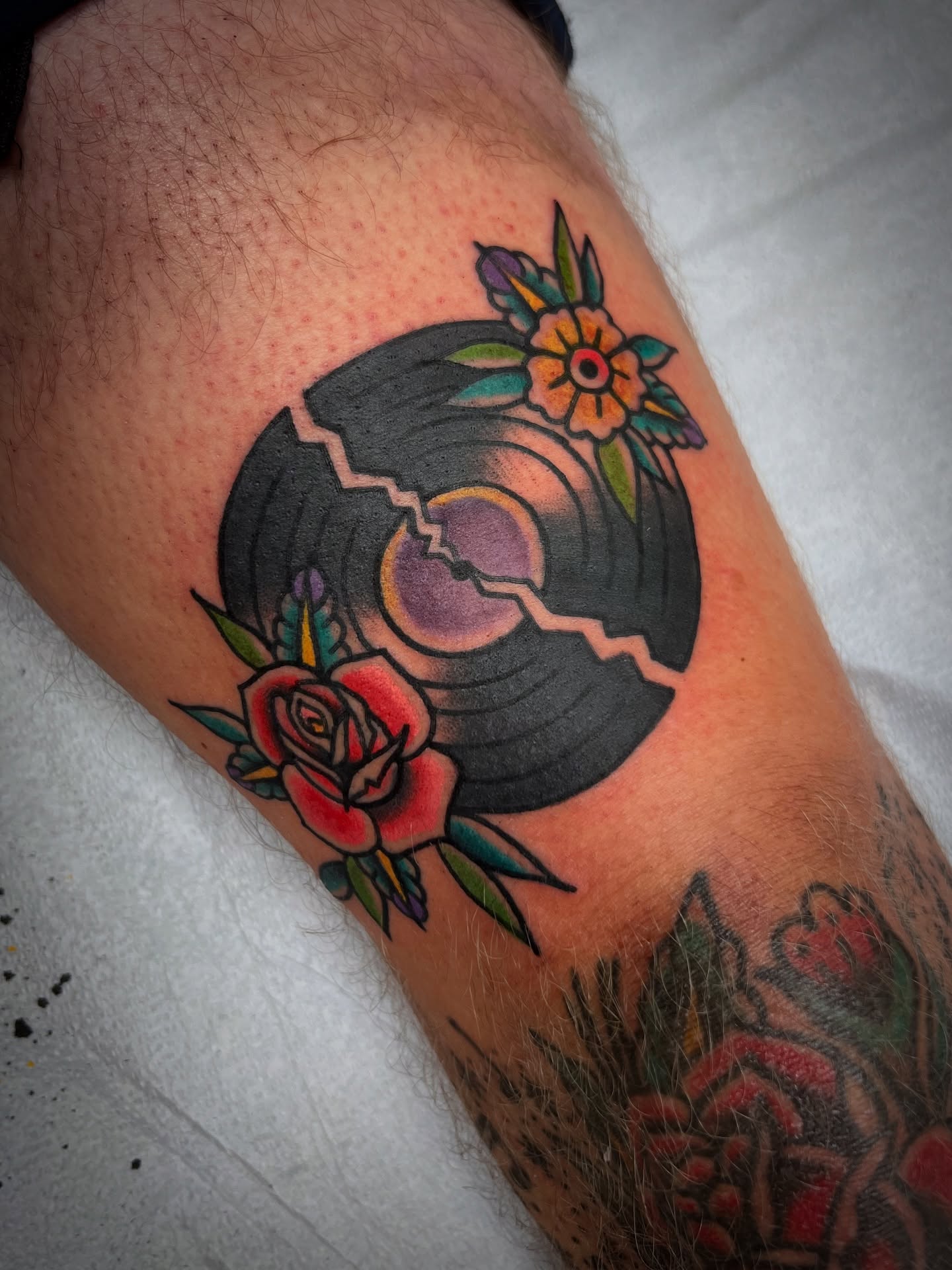 Record and flowers American traditional tattoo on the forearm by Shannon Pagliarini