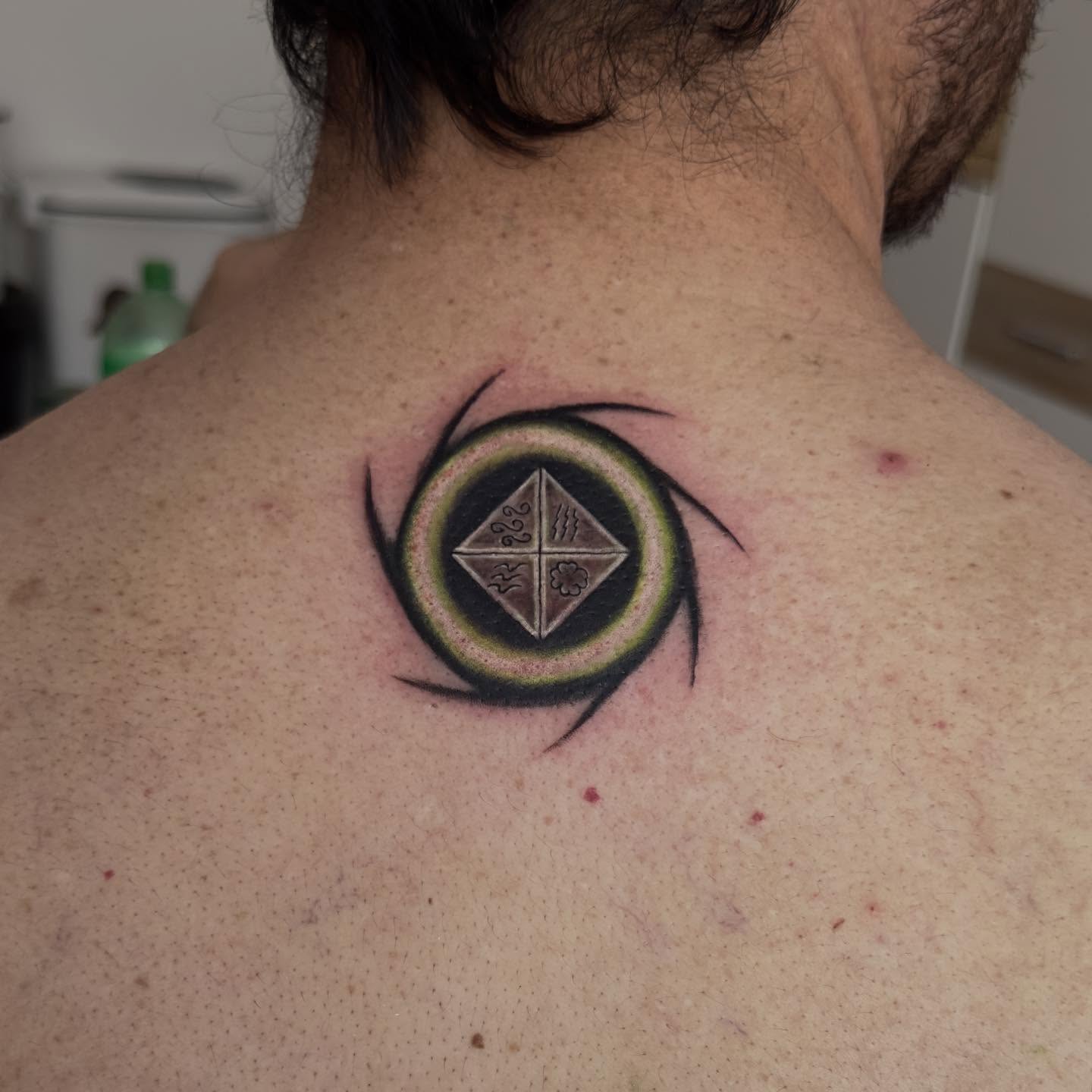 Circle with geometric design geometric tattoo on the back by Kunaytattoo