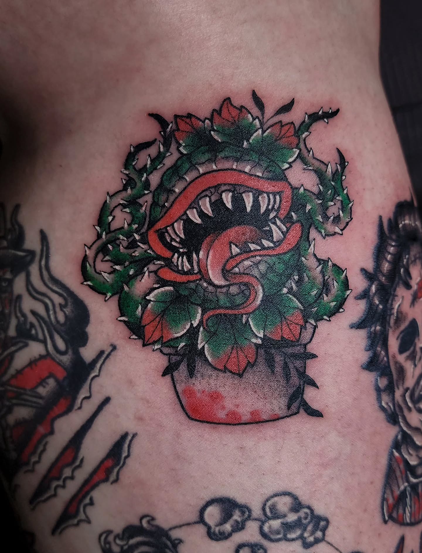 Serpent plant American traditional tattoo on the thigh by Mariah Giovanna Hodgens