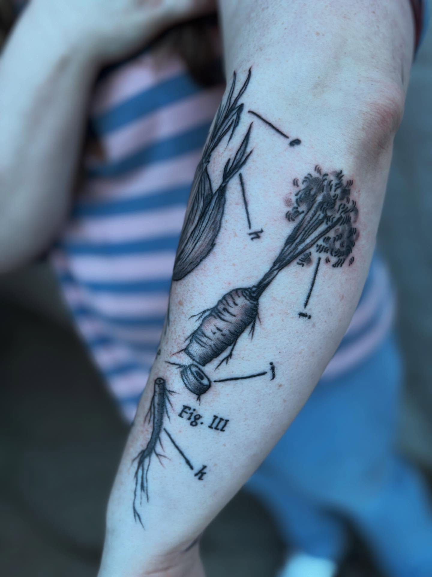 String black and grey tattoo on the forearm by kris noble floyd