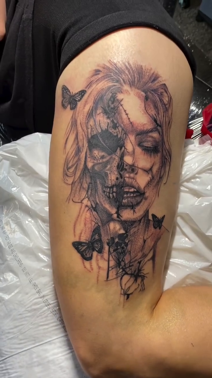 Portrait of a woman with butterflies sketch tattoo on the thigh by Jelani