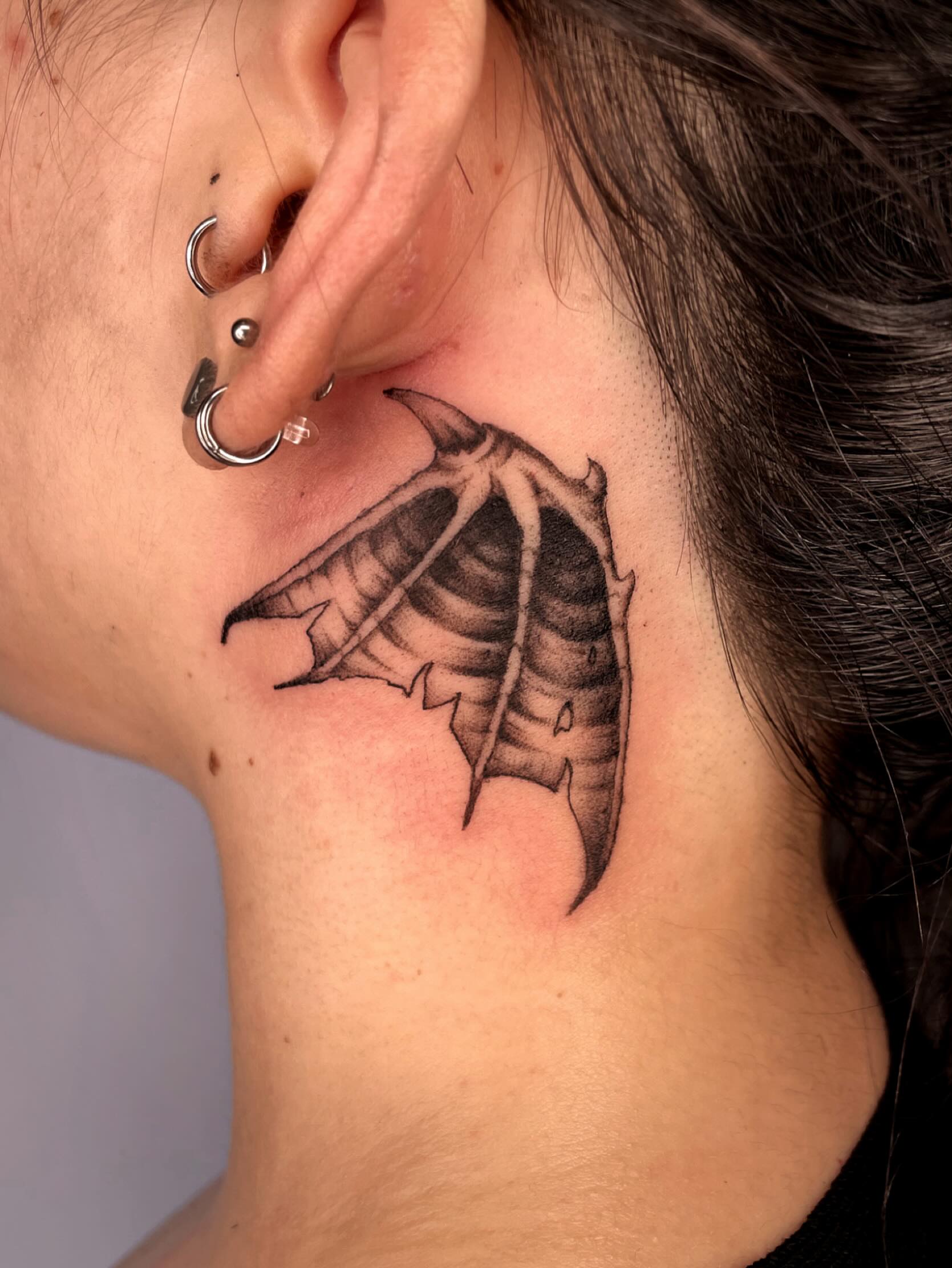 Wing black and grey tattoo on the neck by Vash