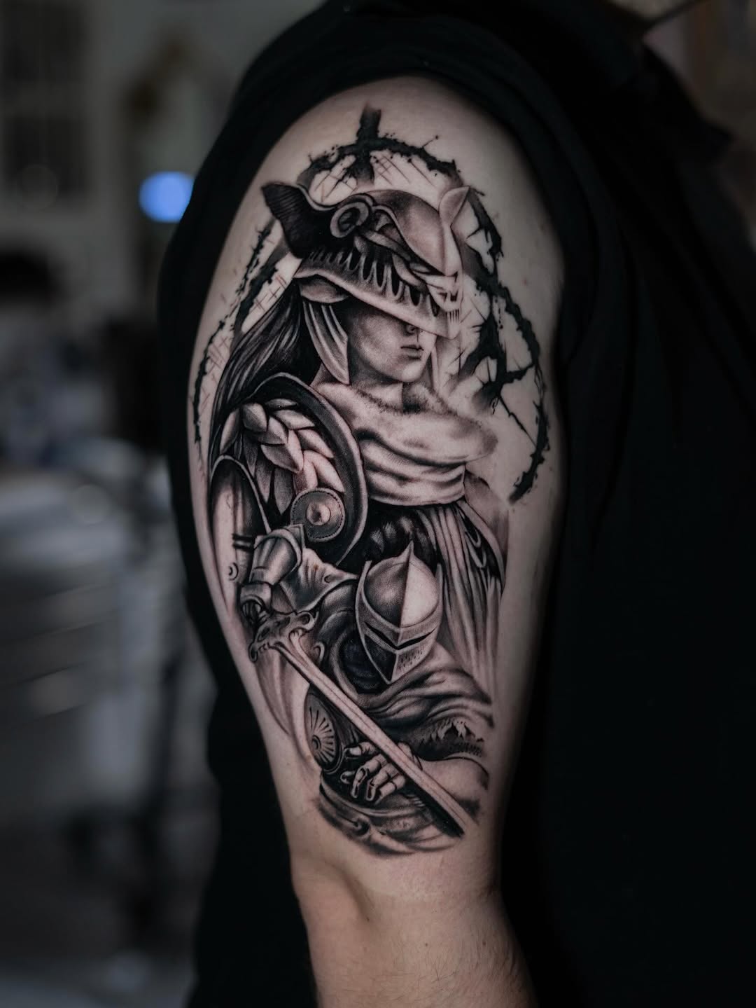Warrior with helmet and sword realism tattoo on the shoulder by Charlotte Tattoo Artist
